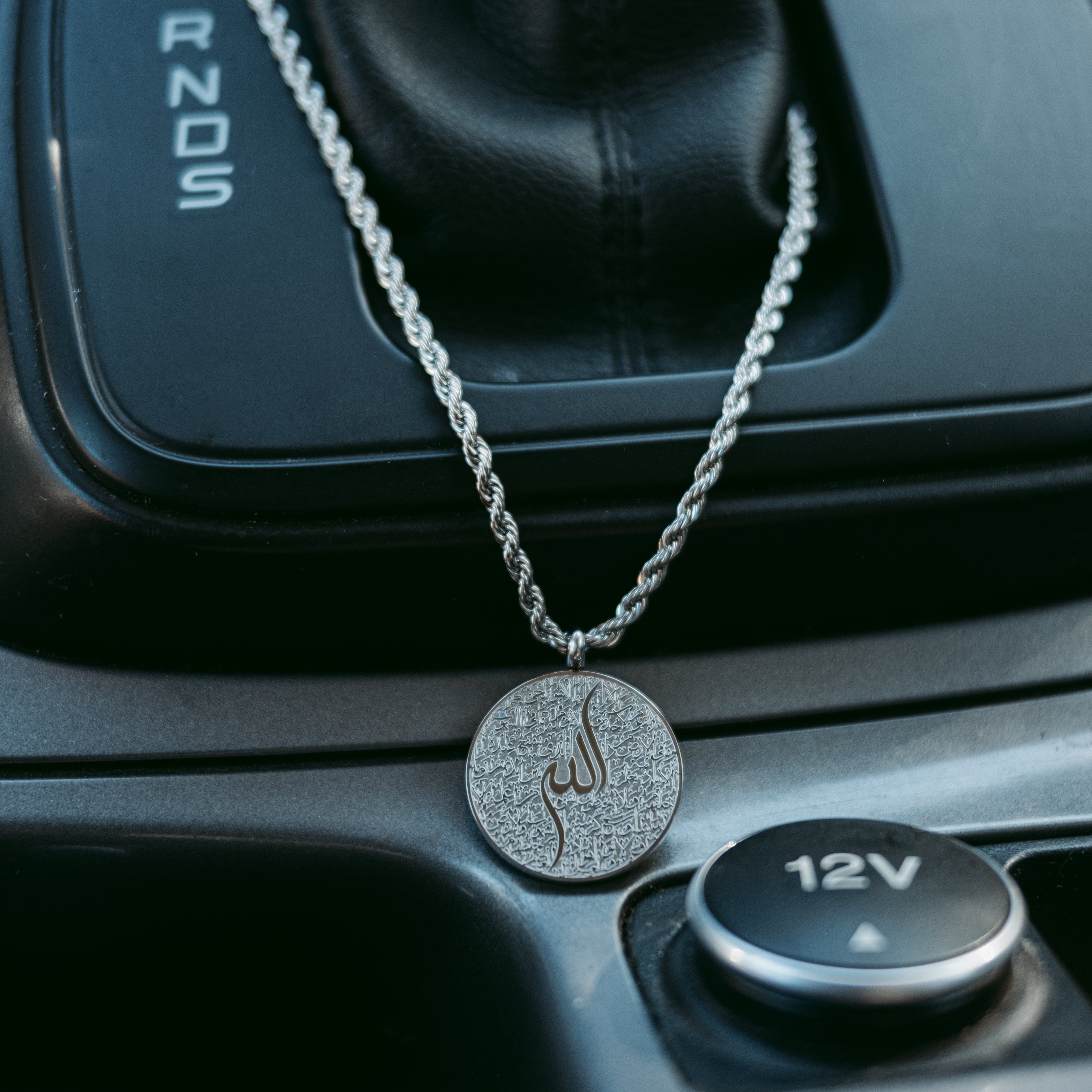 Ayatul Kursi car hanger displayed in a car, adding a spiritual touch to the interior.