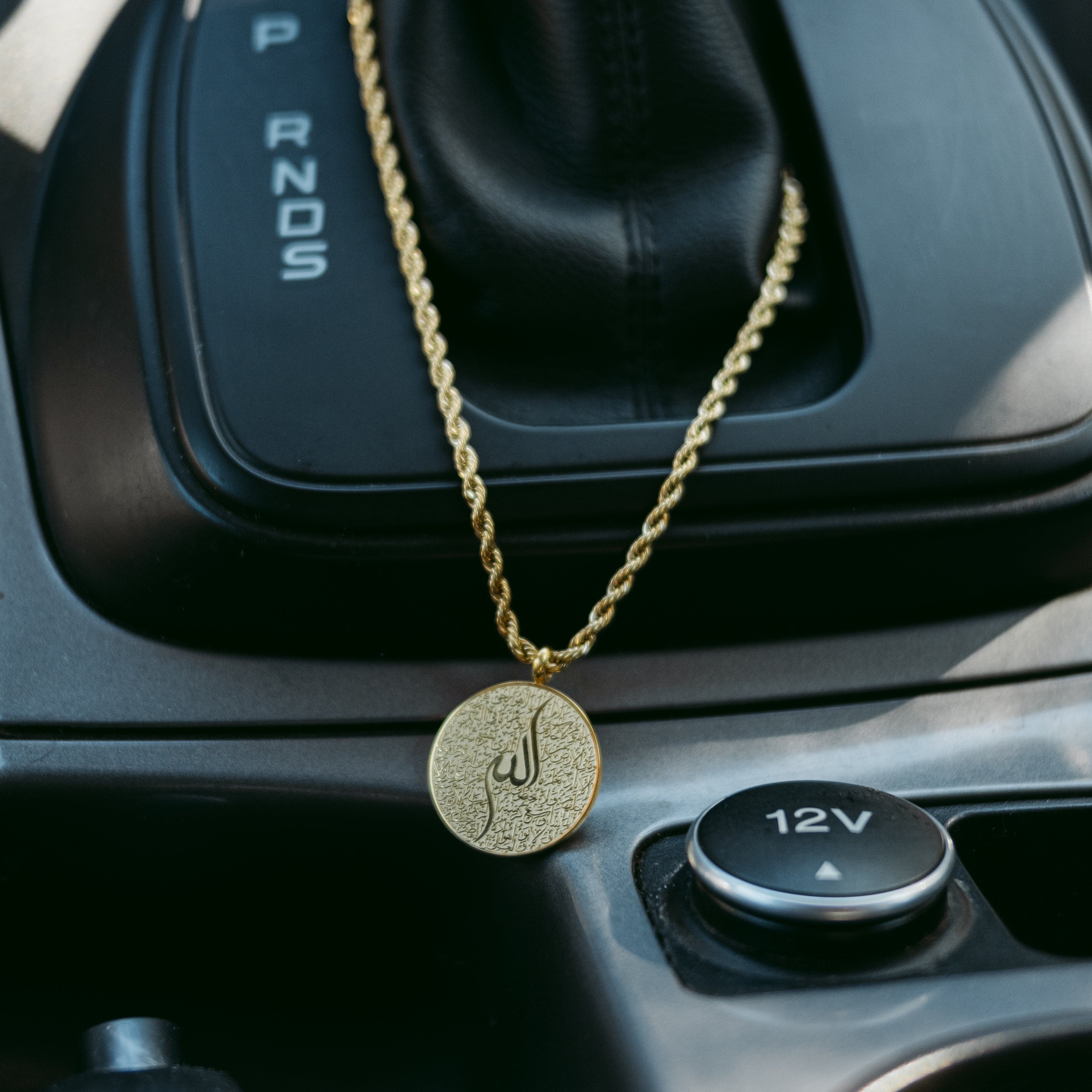 Close-up view of the Ayatul Kursi car hanger showcasing intricate Arabic calligraphy.