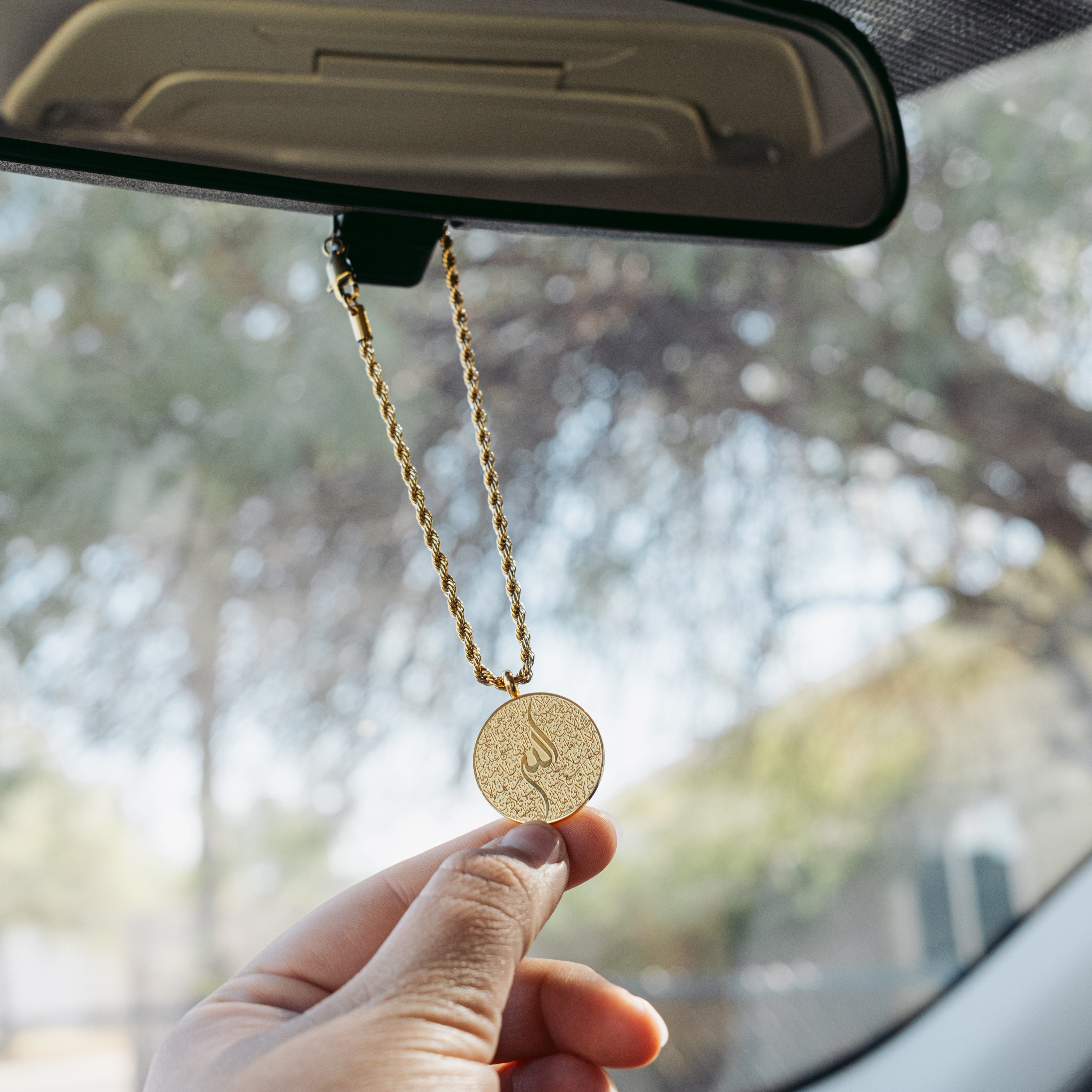 Ayatul Kursi car hanger displayed in a car, adding a spiritual touch to the interior.