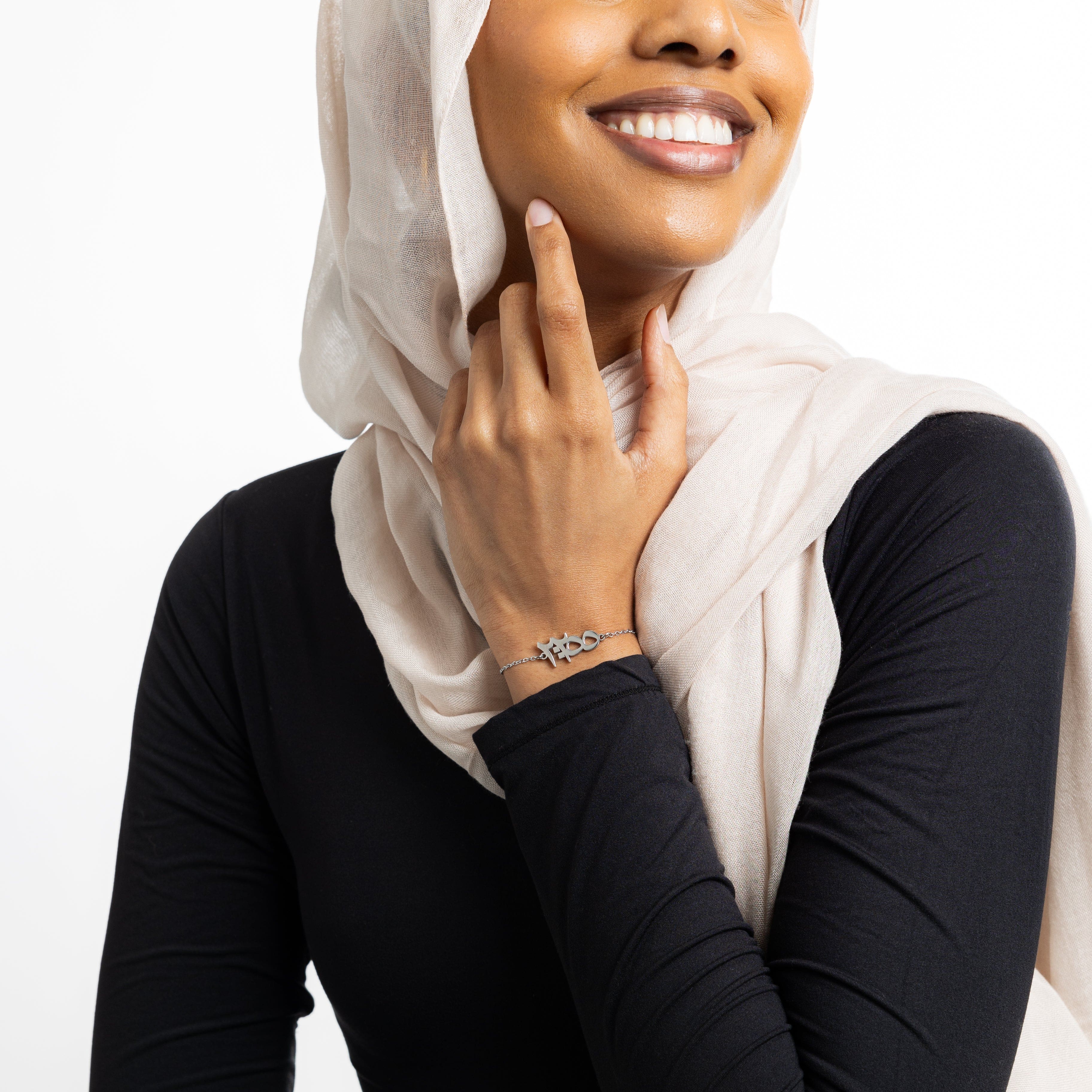 Close-up of the gold plated Ayatul Kursi bracelet highlighting the Arabic calligraphy.