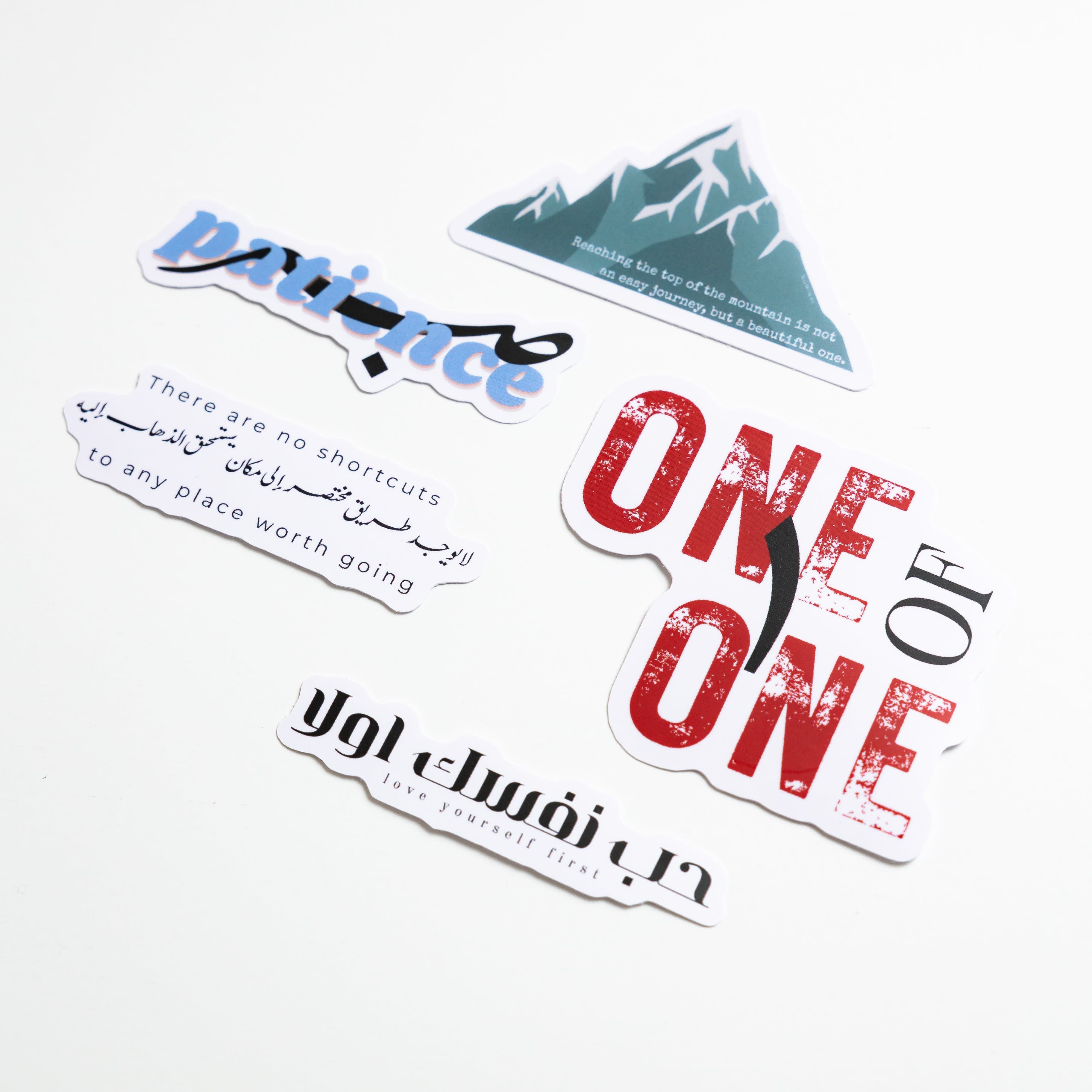Motivational stickers displayed on a laptop, adding a personal touch to workspace decor.