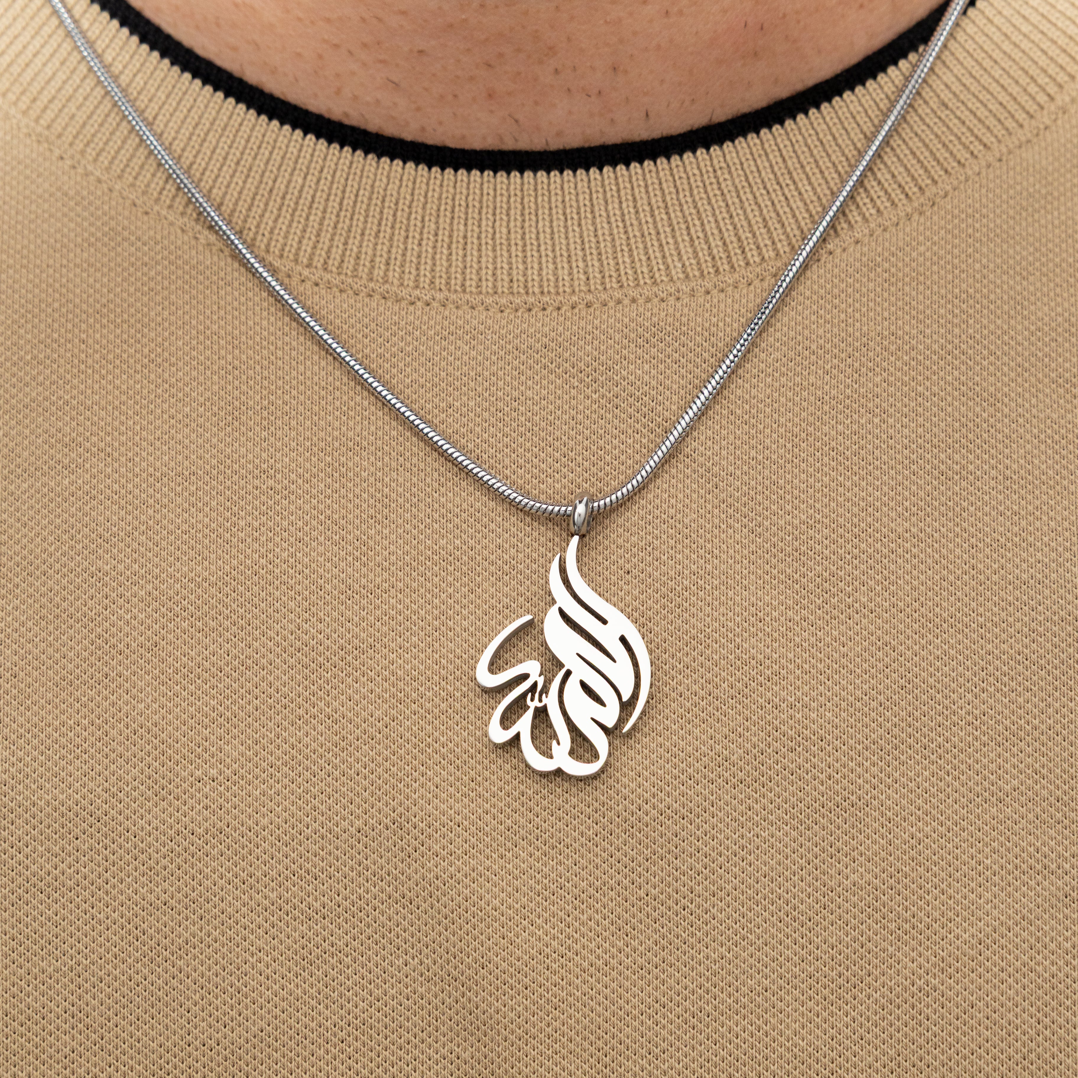 Close-up of the pendant of the Alhamdulillah necklace, highlighting the beautiful calligraphy.