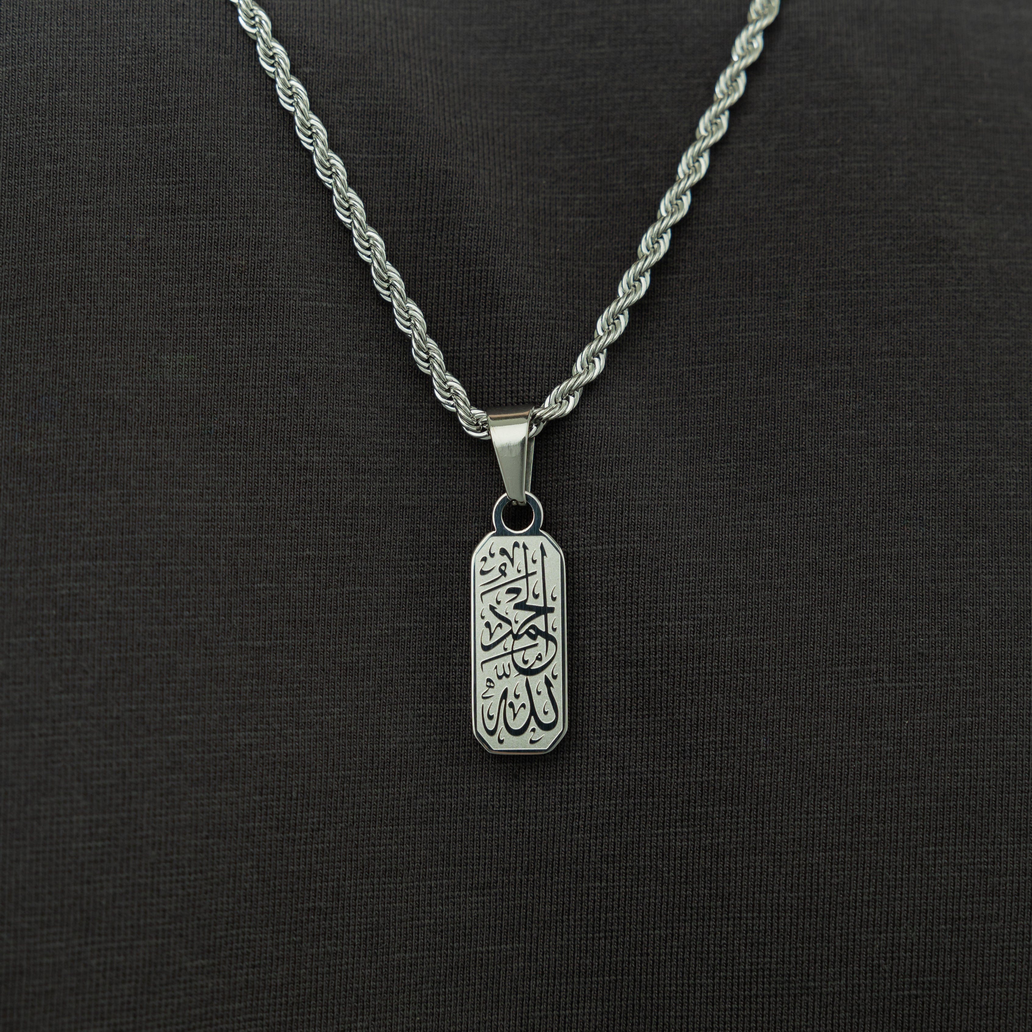 Alhamdulillah tag necklace worn by a man, emphasizing its stylish and meaningful design.