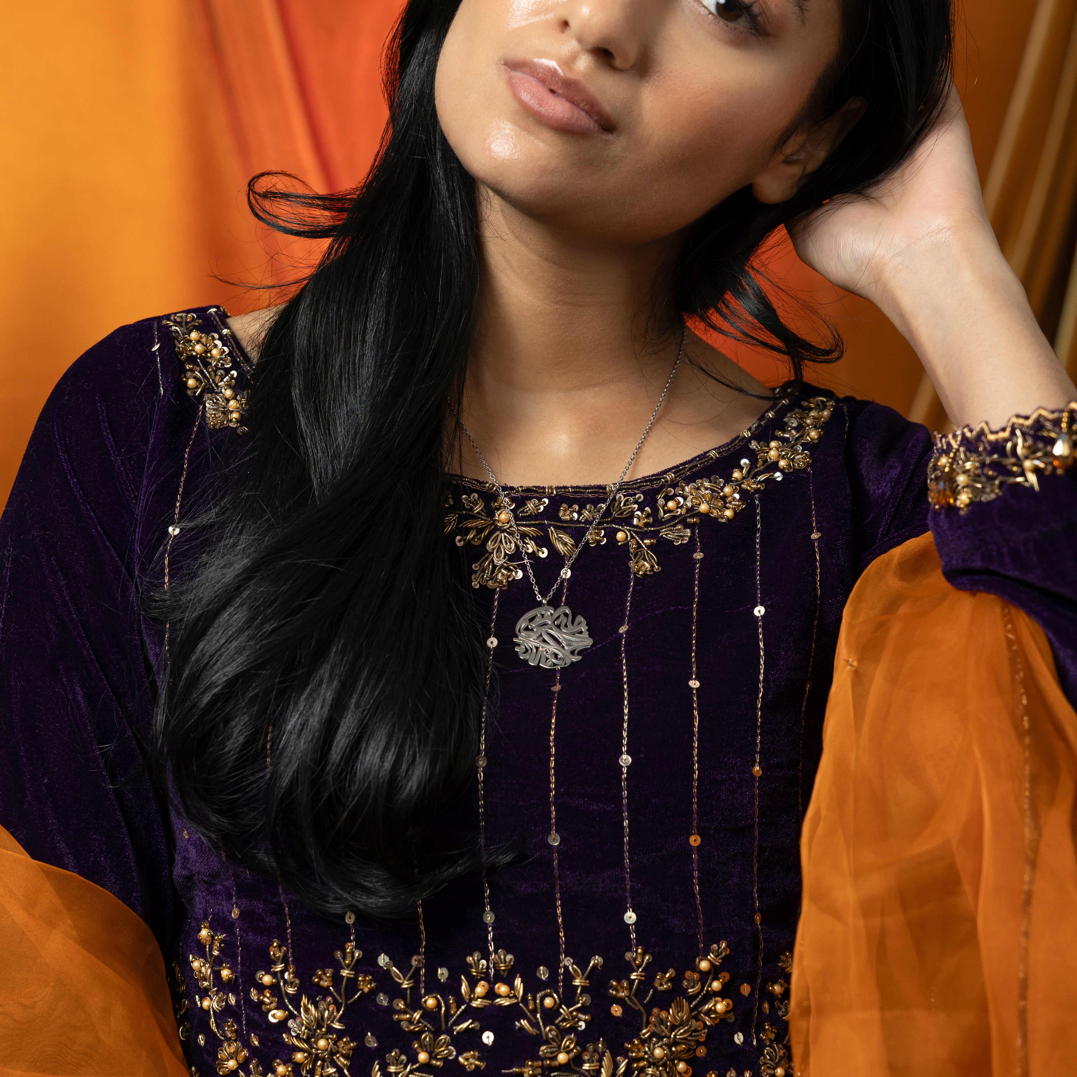 Model wearing the Elysian Relief Necklace, emphasizing its versatility for both casual and formal outfits.