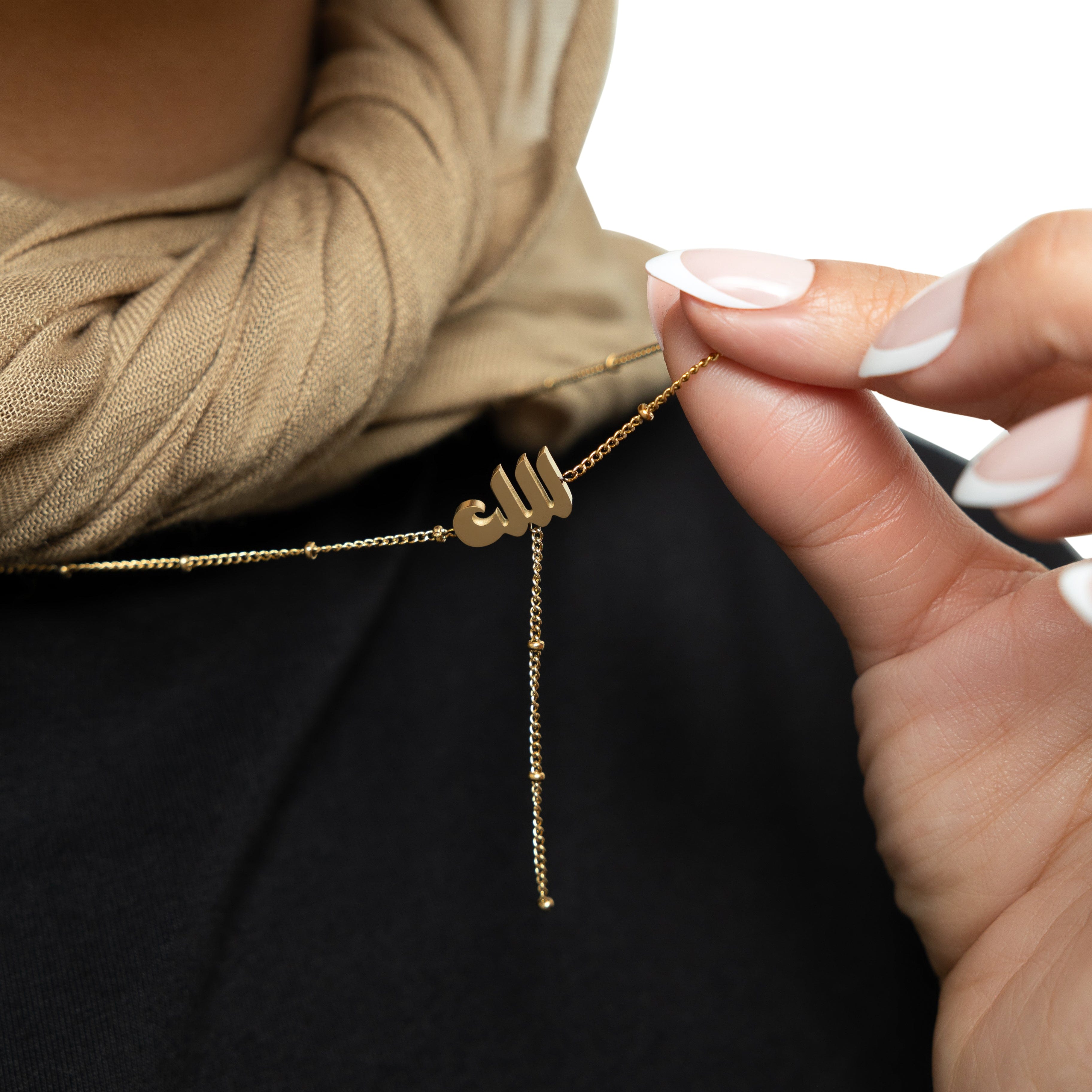 Close-up of the Allah pendant on a delicate dotted chain, highlighting its hypoallergenic design.