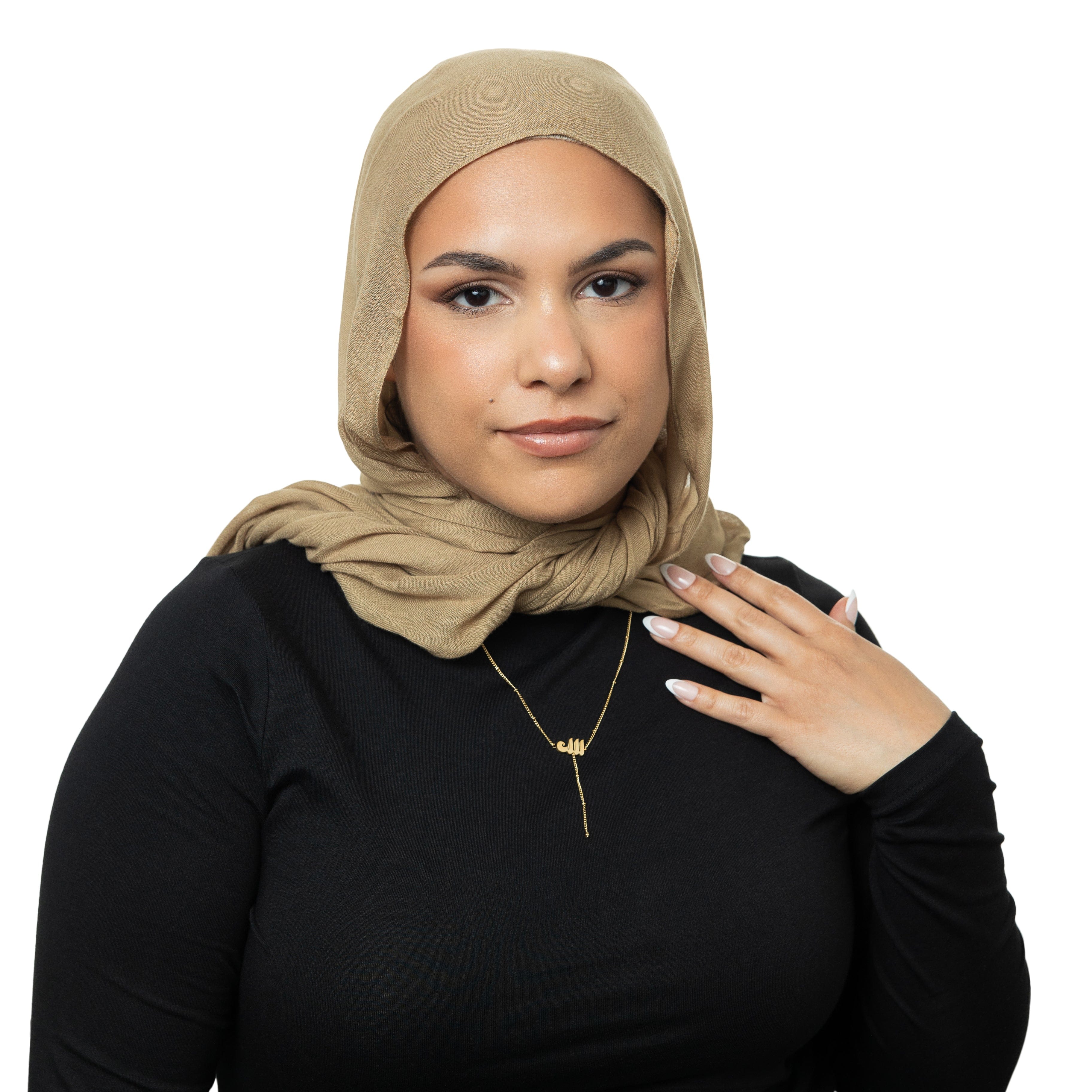 Chic Allah lariat necklace showcased against a soft velvet background.