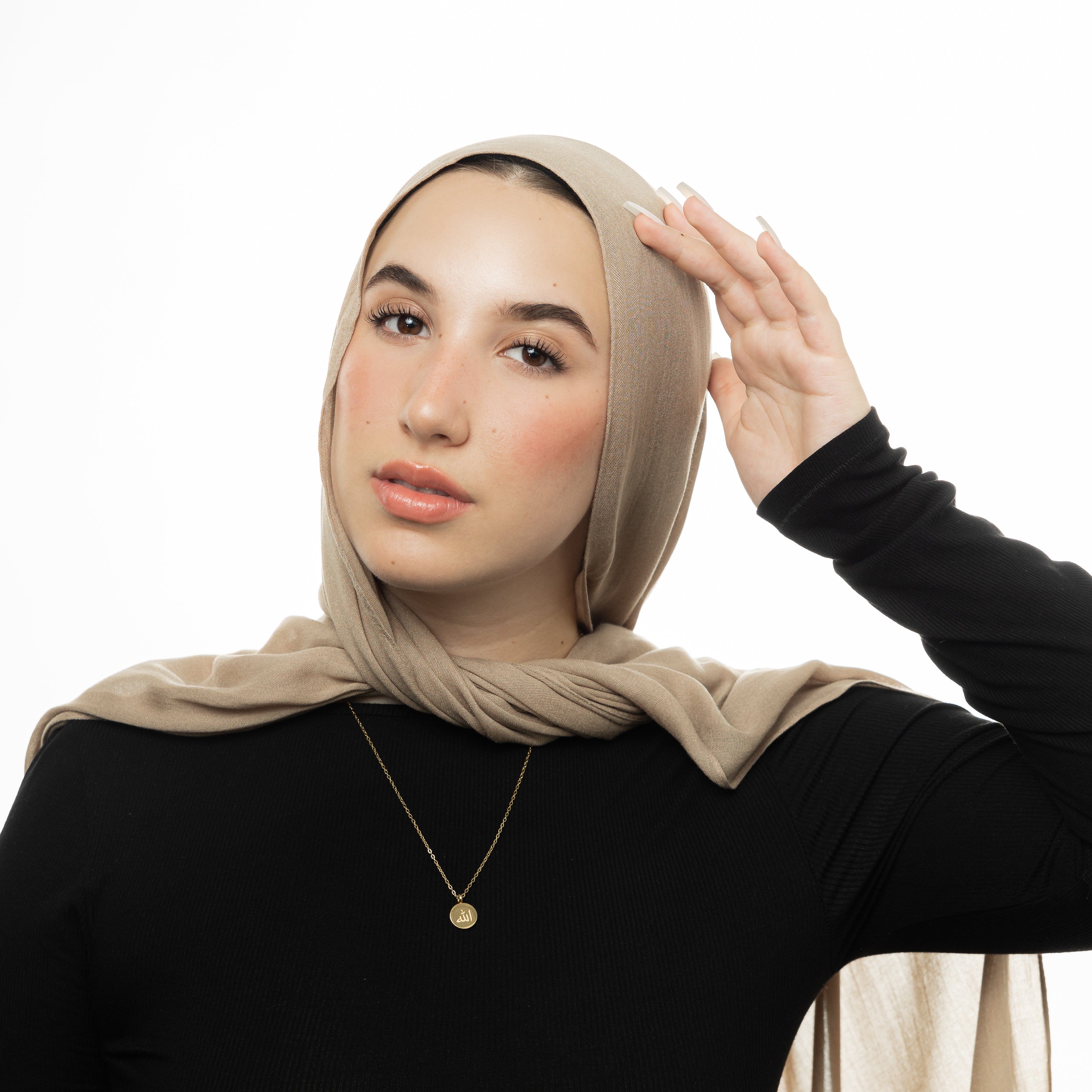 Woman wearing the Allah necklace, emphasizing its elegance and comfort.