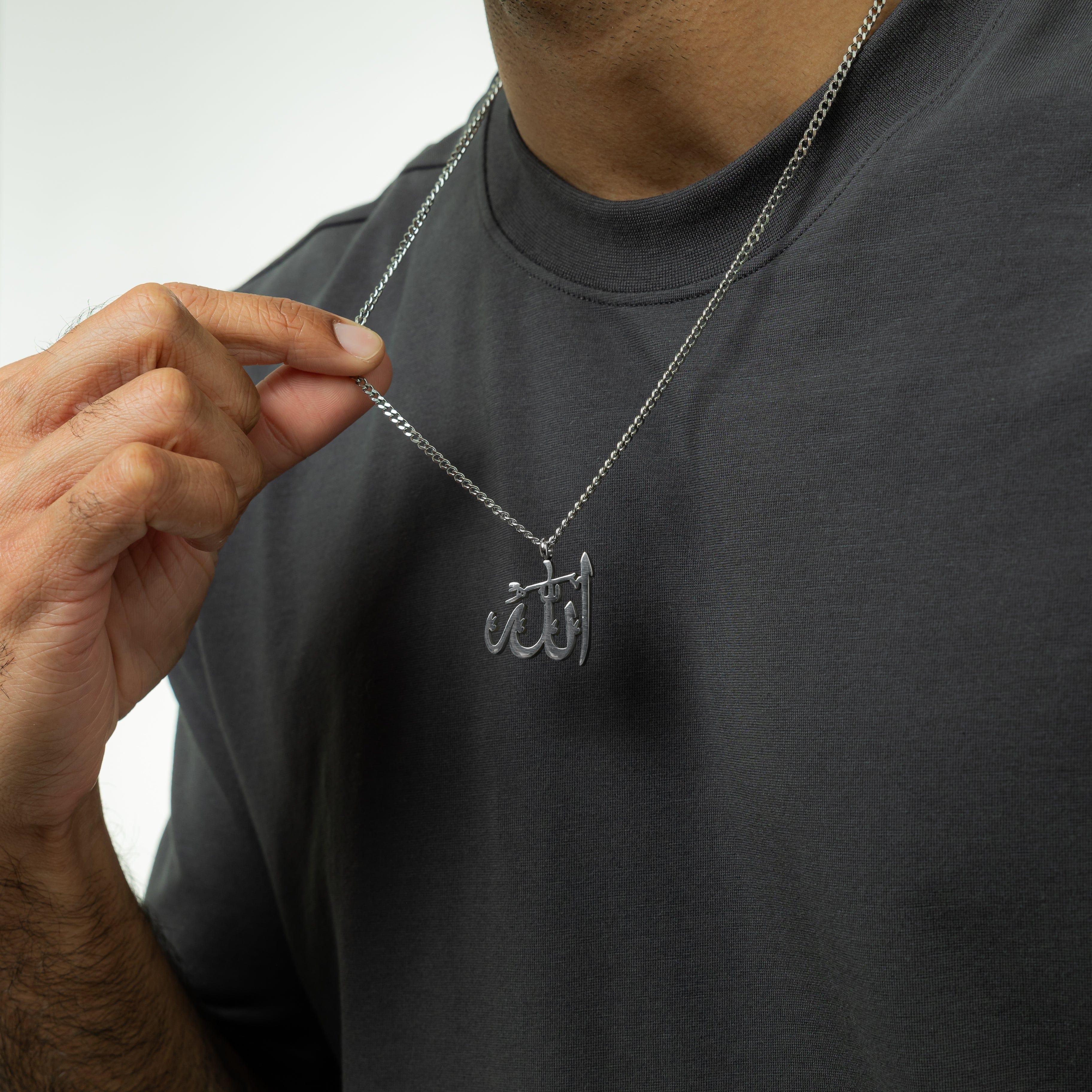 The Allah pendant necklace displayed in a velvet drawstring pouch, ideal for gifting.
