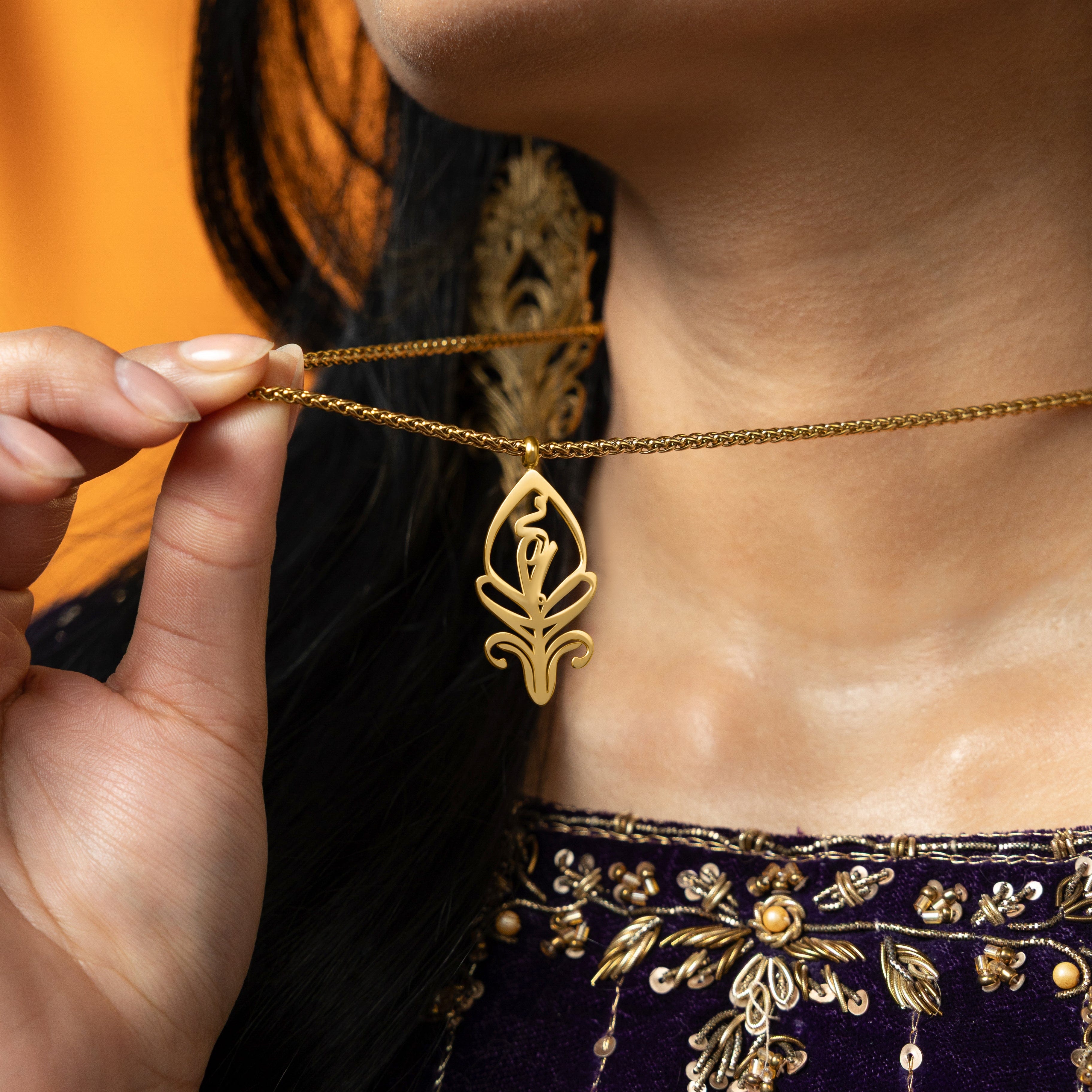 SALAAM necklace worn by a model, highlighting its elegance and versatility.