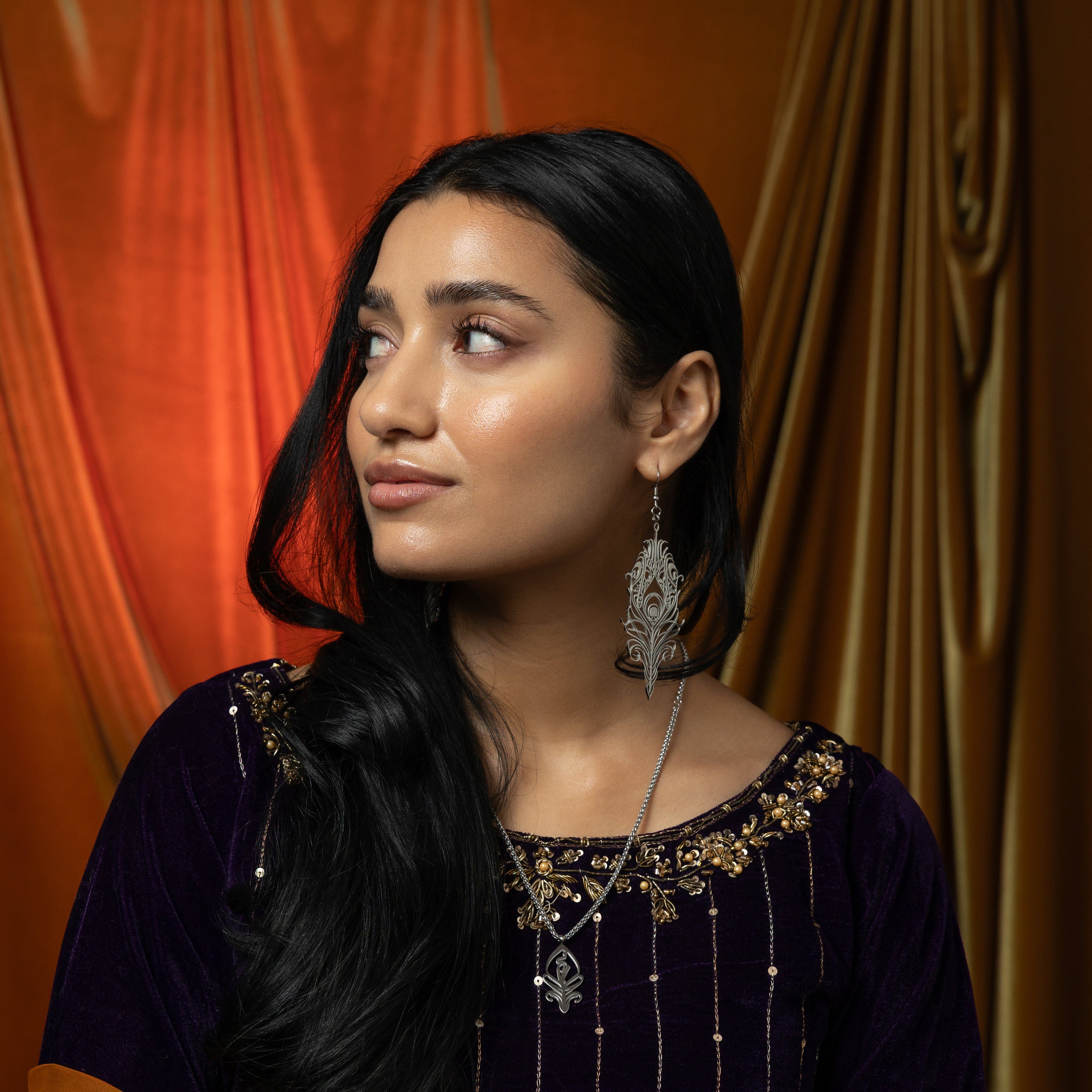 SALAAM Arabic calligraphy necklace displayed in a Nominal velvet pouch.