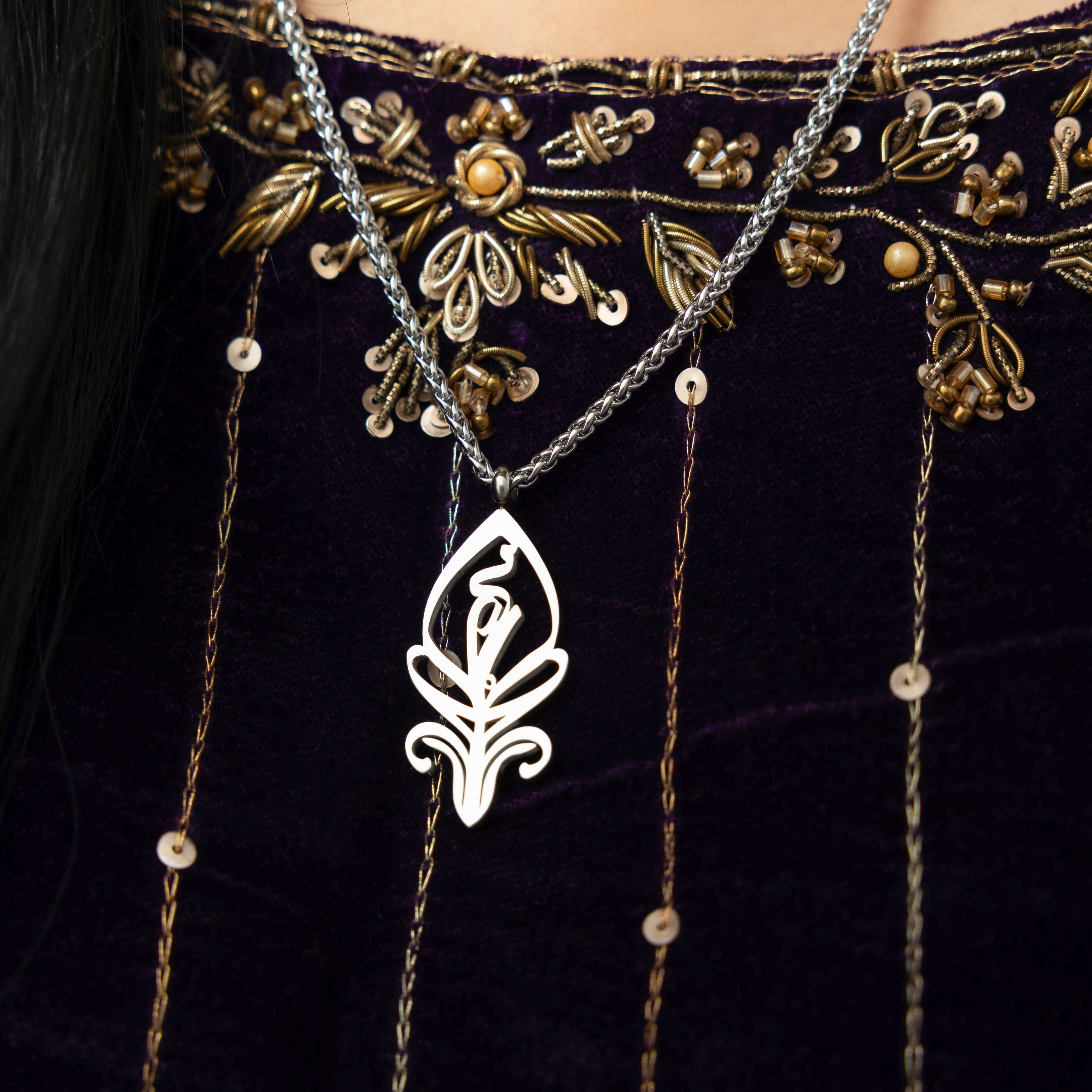Close-up of the SALAAM Arabic calligraphy necklace showcasing its intricate design.