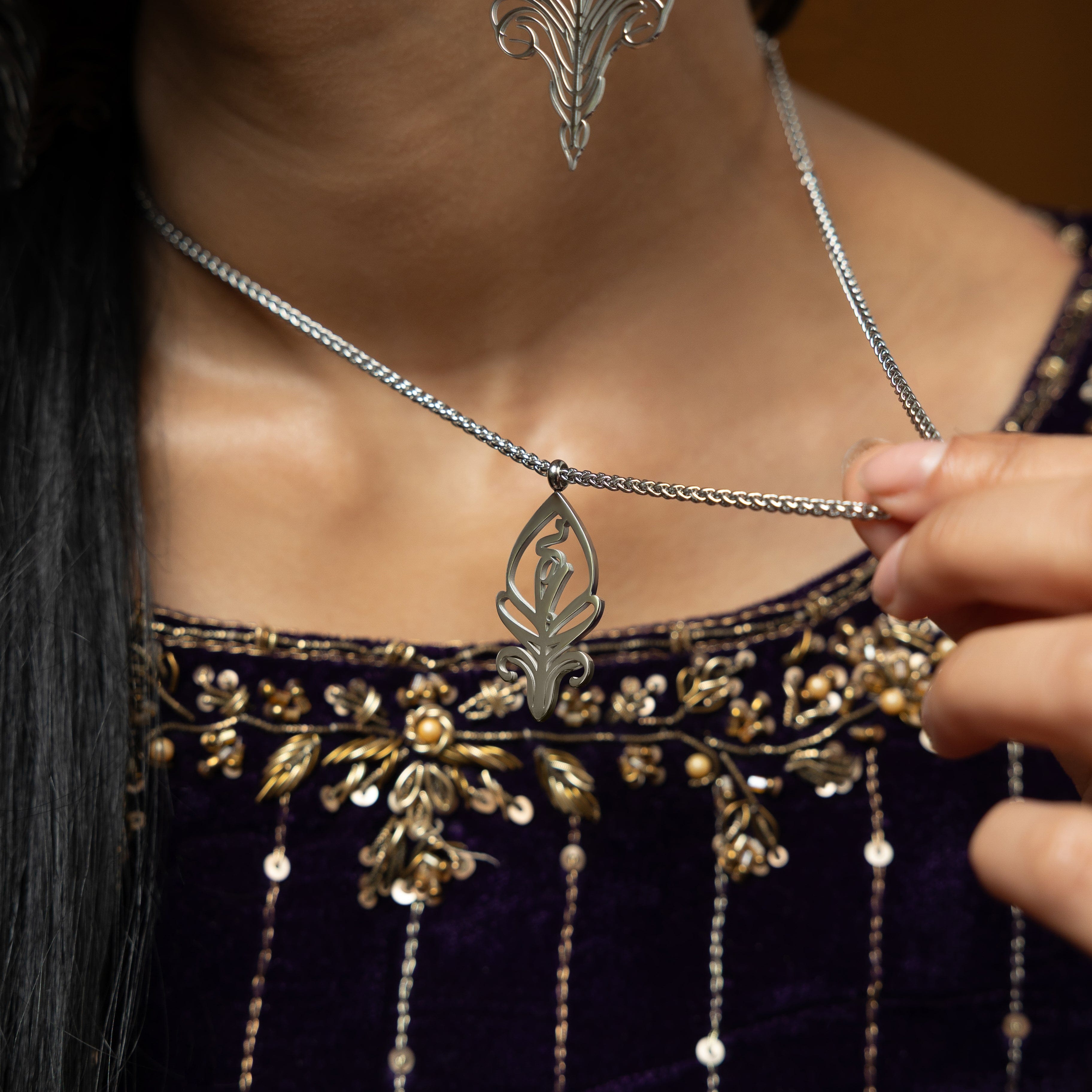 Close-up of the SALAAM Arabic calligraphy necklace showcasing its intricate design.