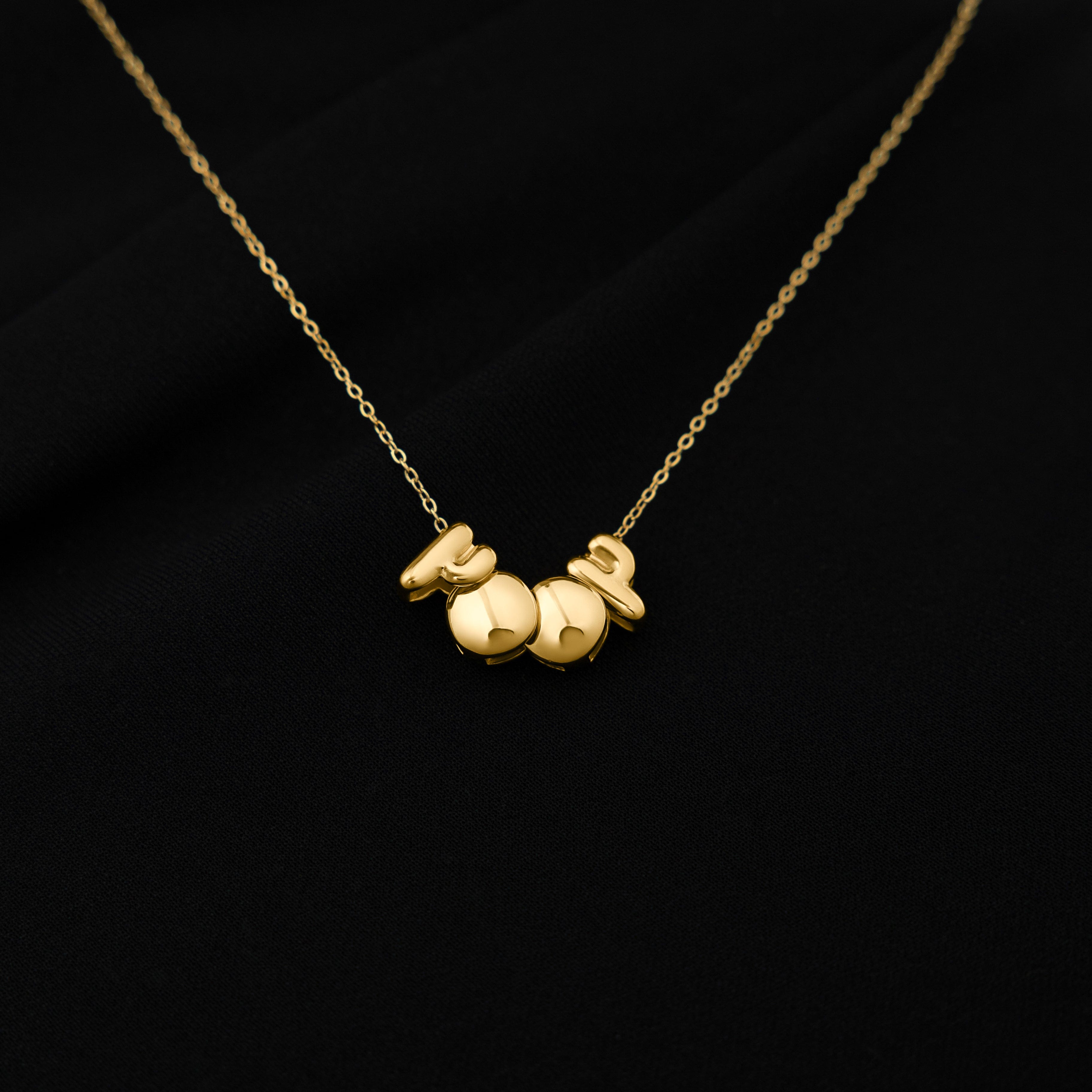 The birthyear charm necklace displayed in a velvet pouch, highlighting its luxurious packaging.