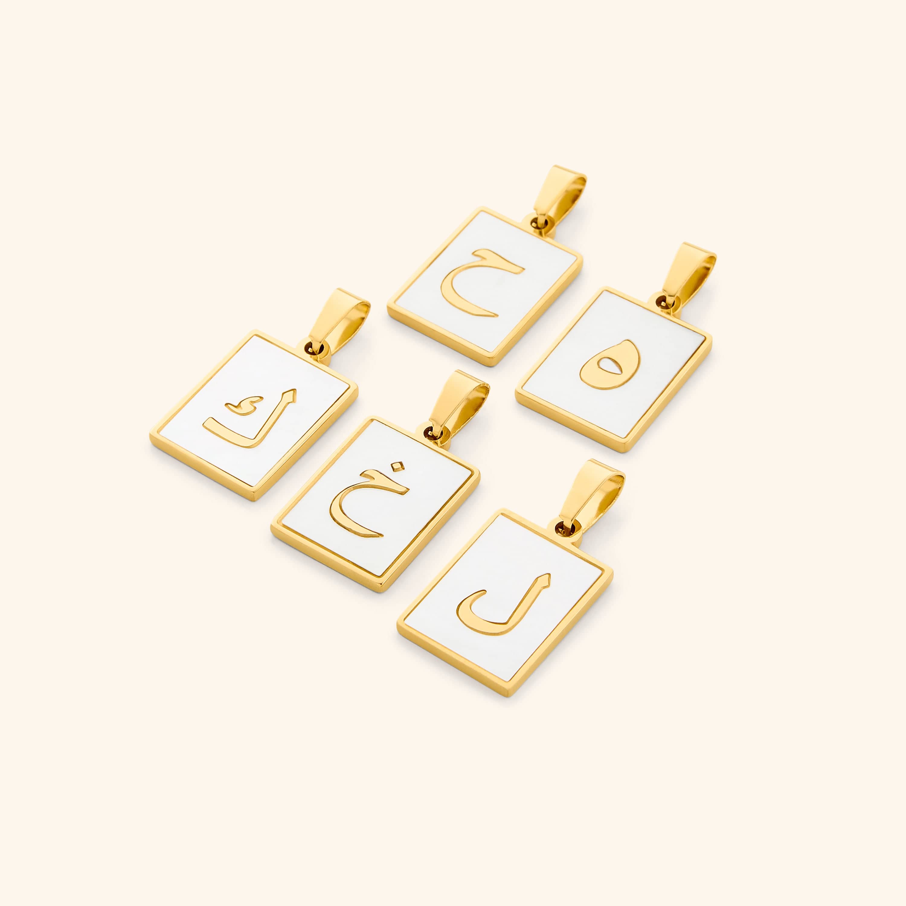 Nominal velvet pouch holding Arabic letter charms, perfect for gifting or personal use.