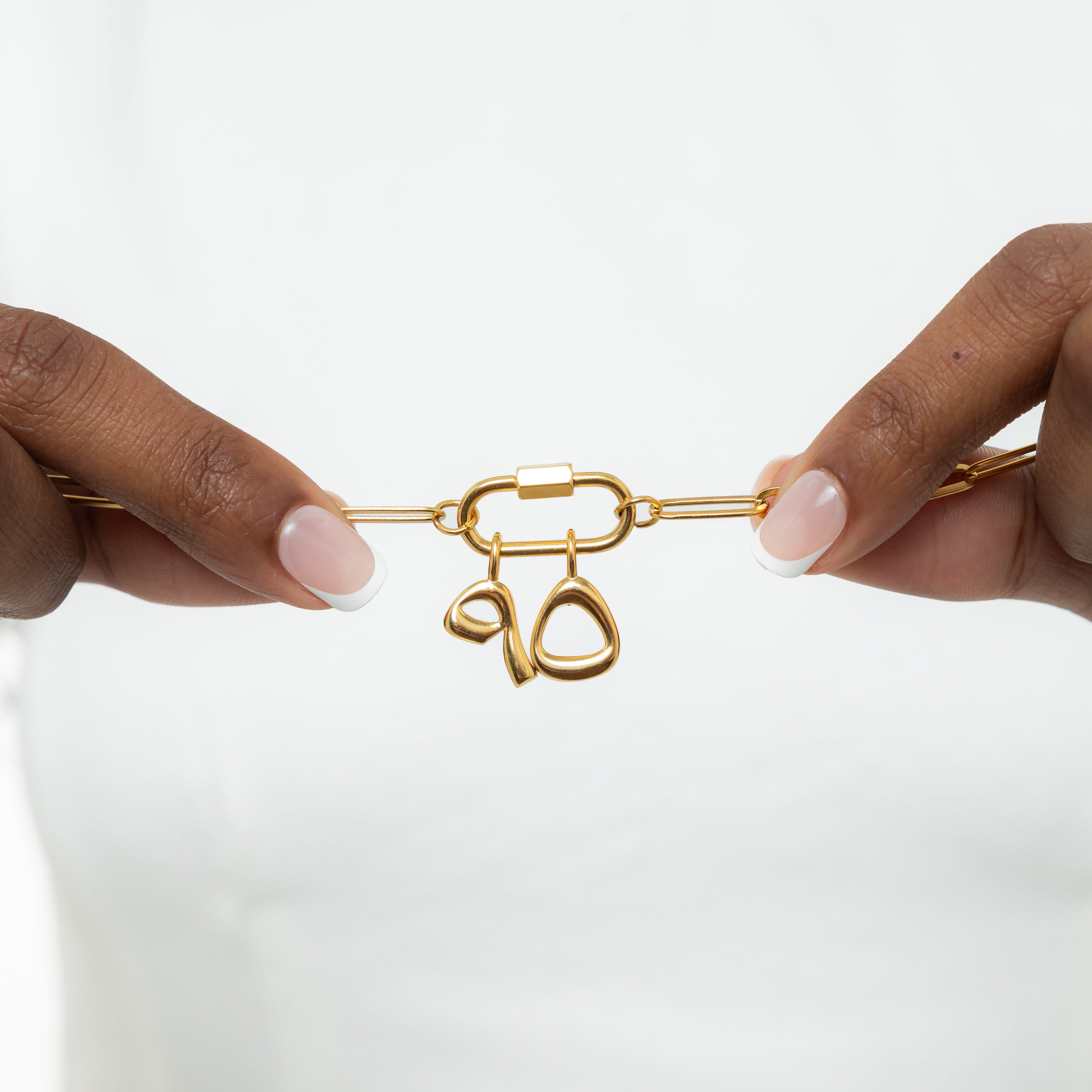 Close-up of personalized number charms with a velvet pouch, perfect for gifting.