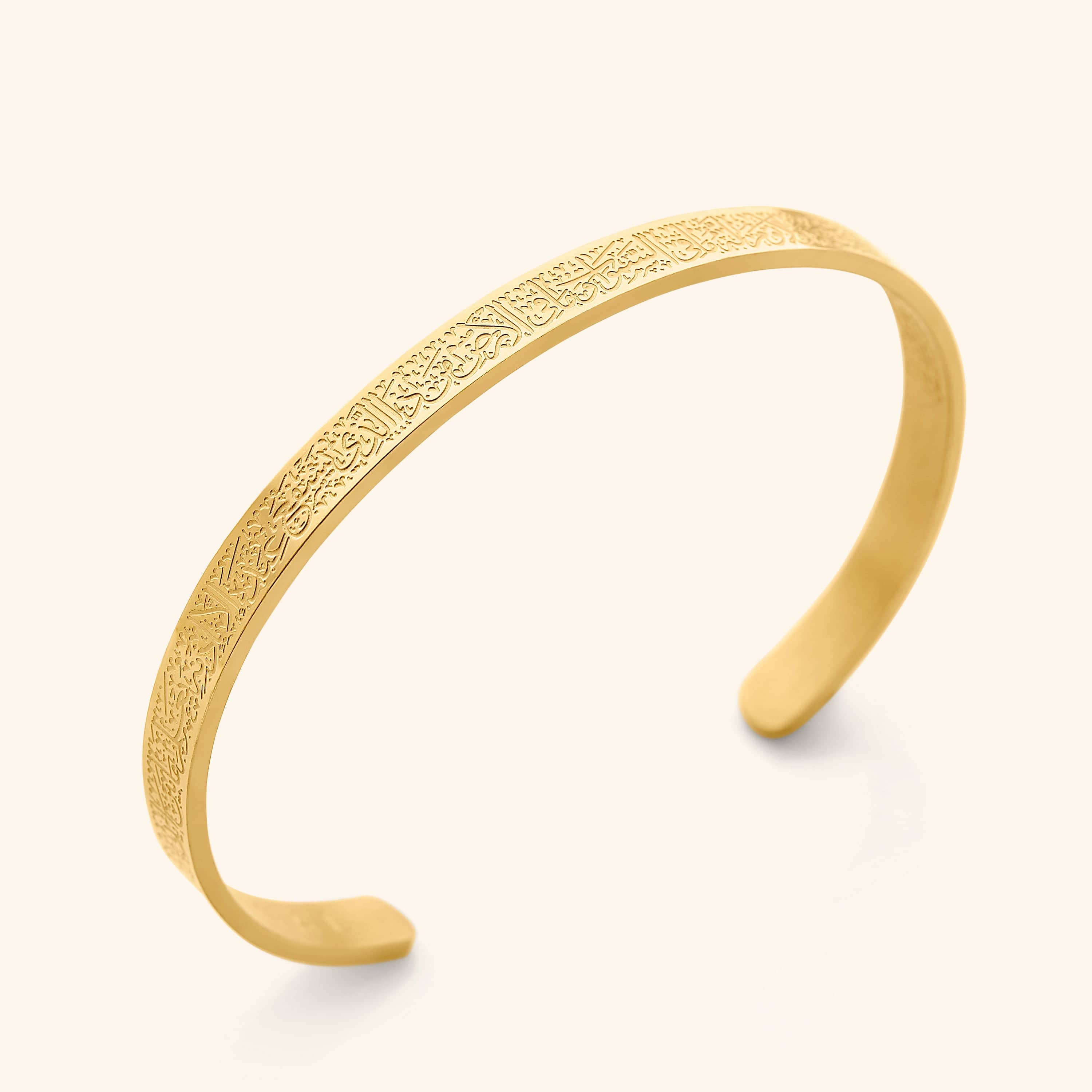 Close-up of Ayatul Kursi calligraphy bracelet showing detailed engraving on gold cuff