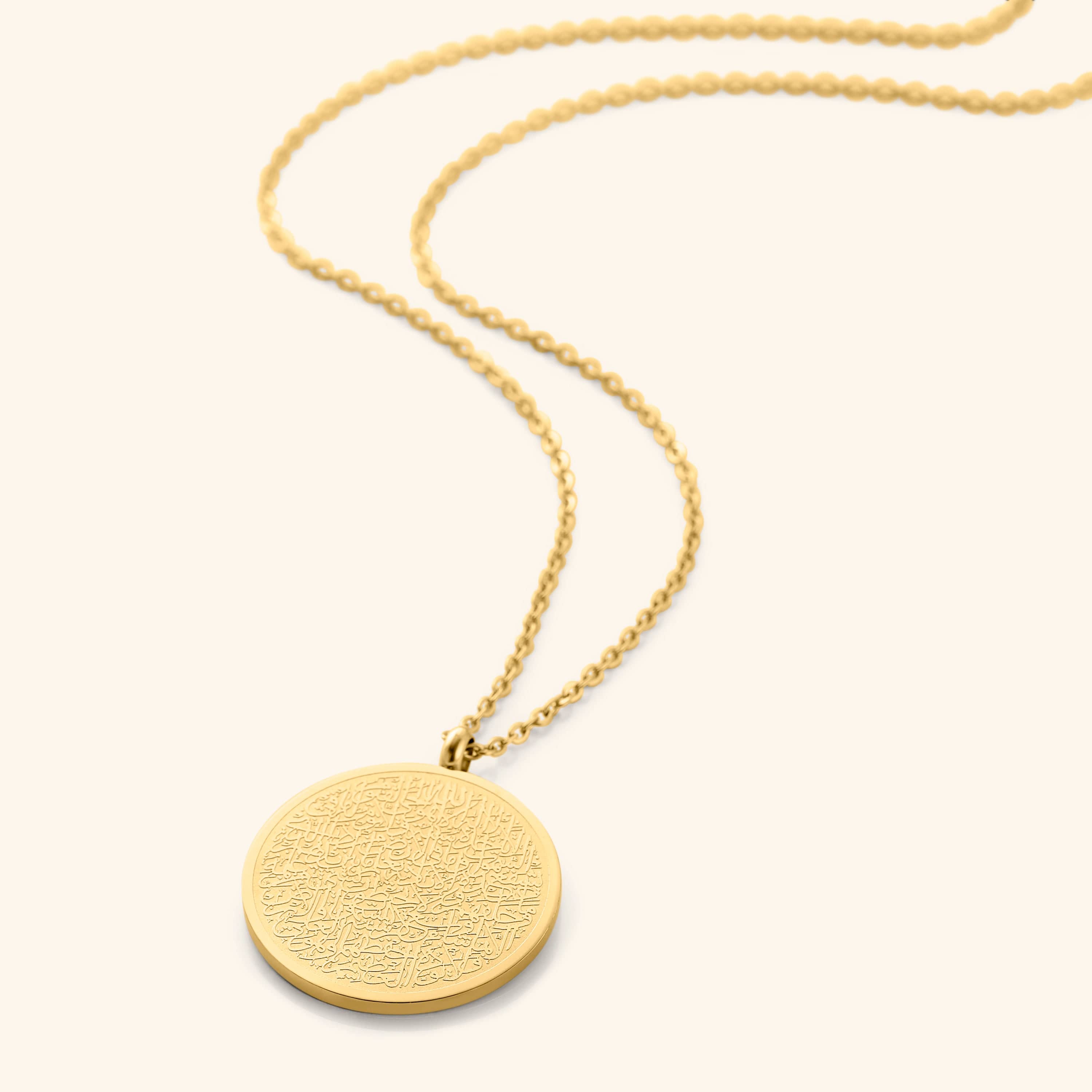 Close-up of the Ayatul Kursi necklace highlighting the intricate Arabic calligraphy on the pendant.