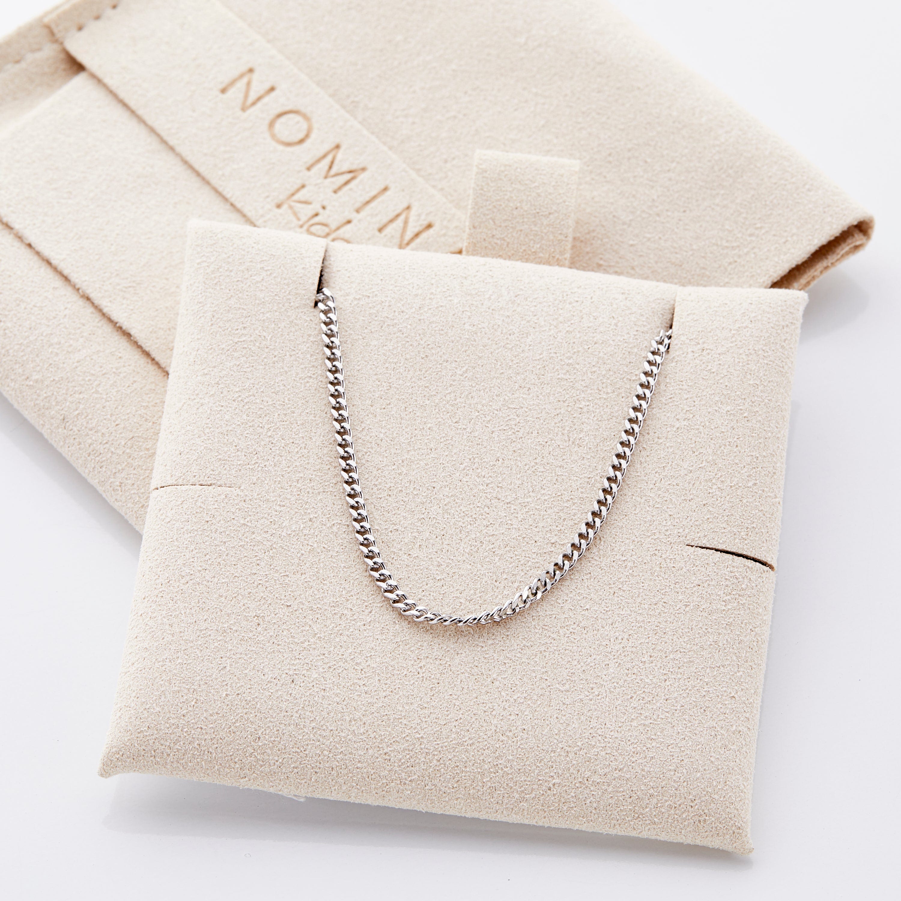 Cuban chain bracelet for boys displayed in a velvet pouch, highlighting its waterproof feature.