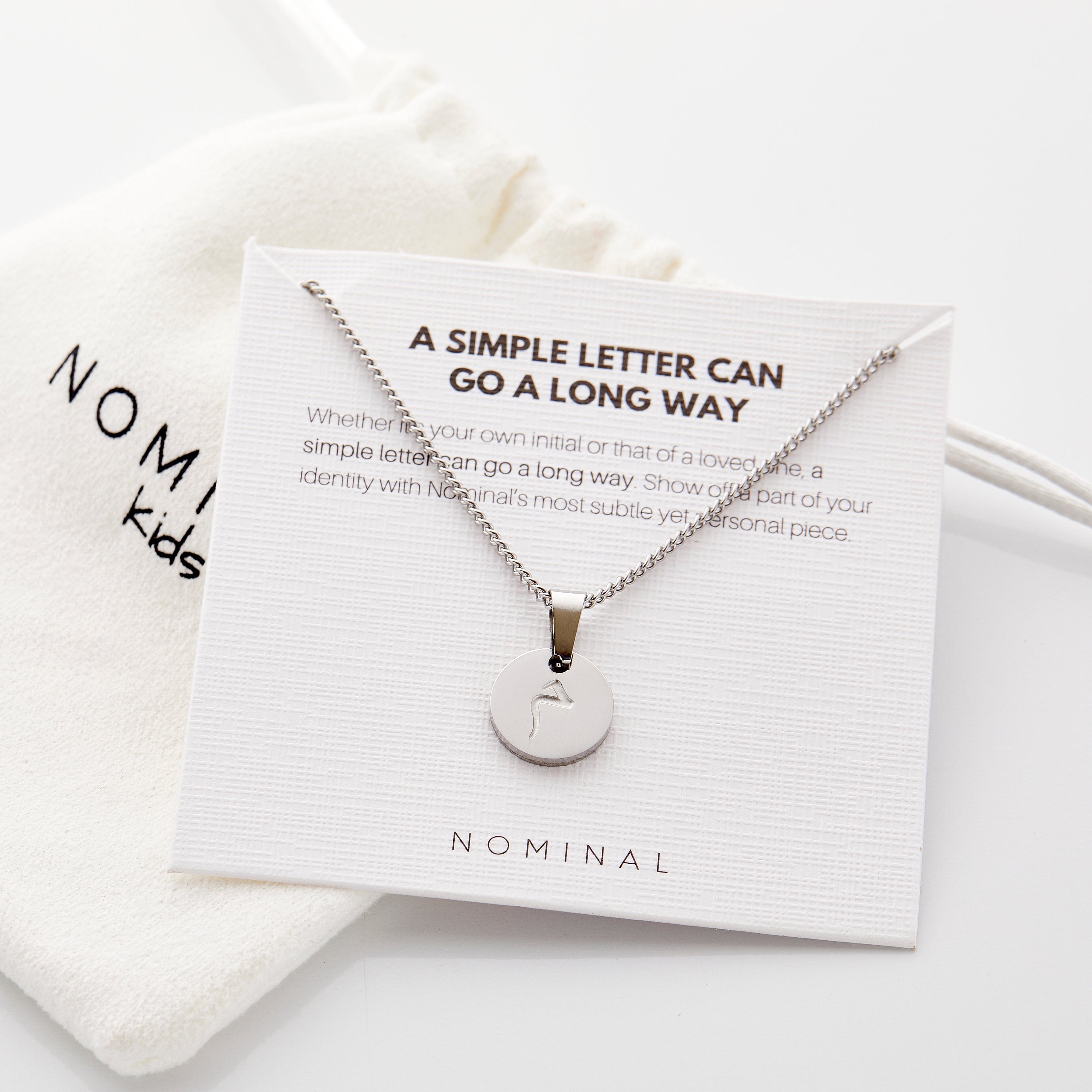 Elegant packaging of the personalized necklace in a velvet drawstring pouch, ready for gifting.