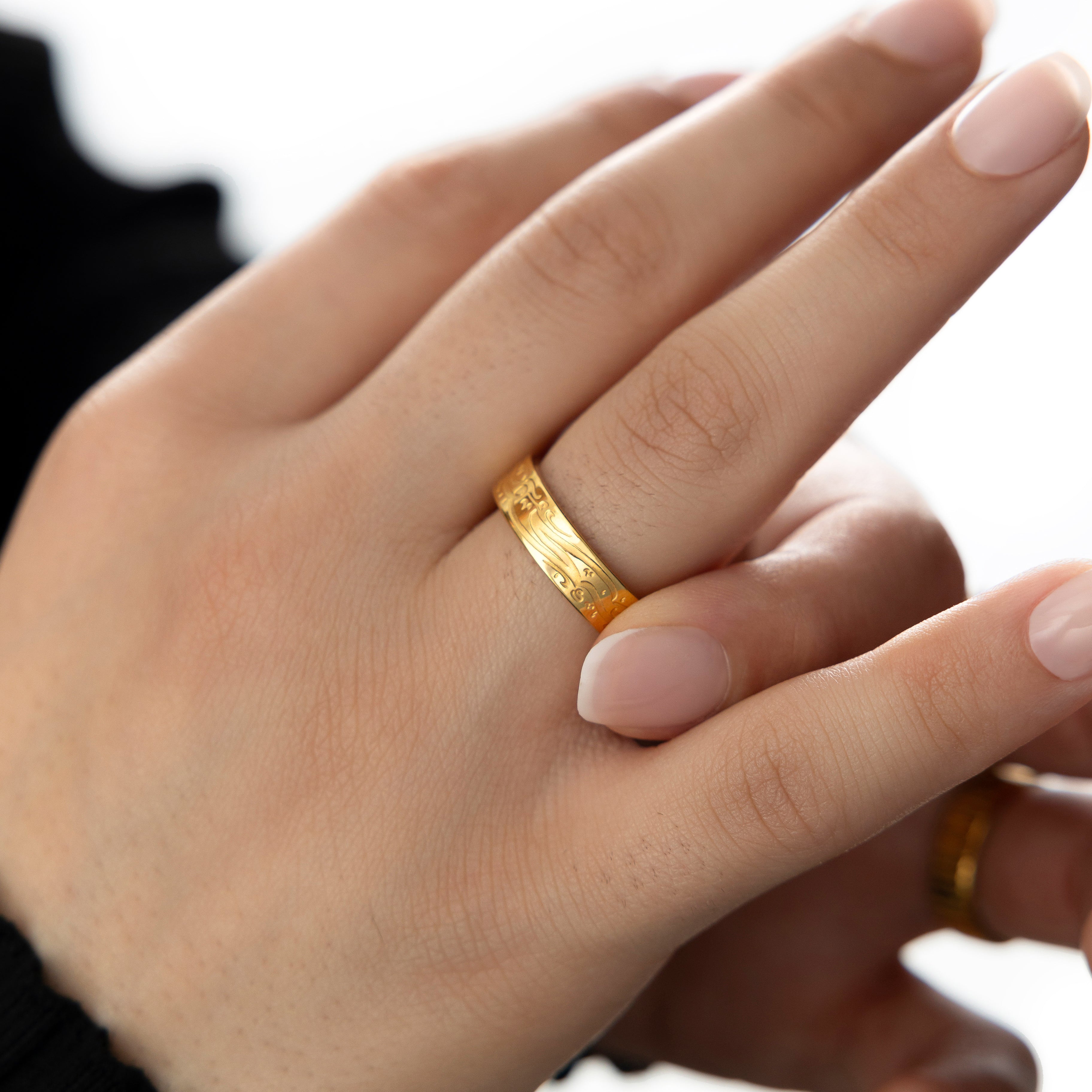 Lifestyle image of a woman wearing the engraved ring, symbolizing faith and divine connection.