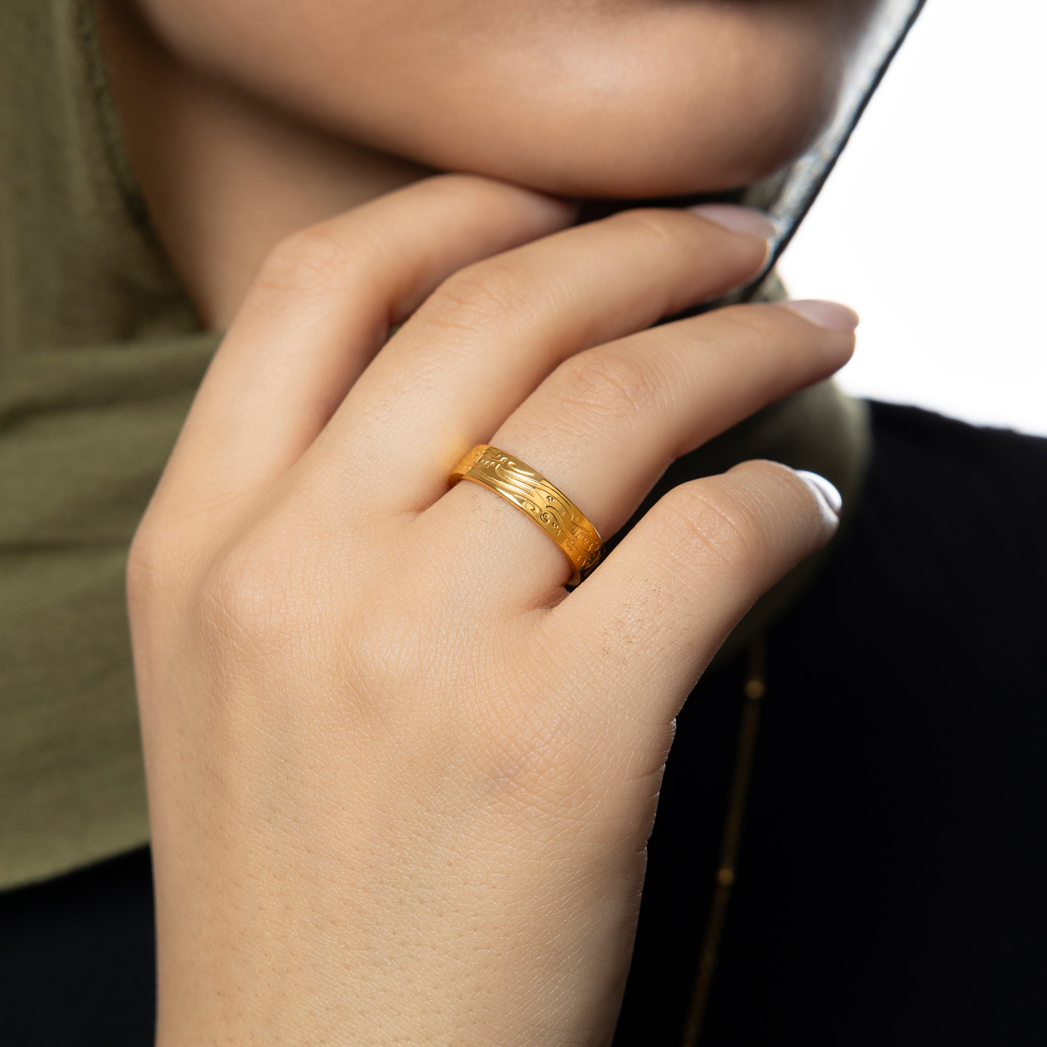Elegant presentation of the calligraphy ring in a velvet pouch, highlighting its gold plating.