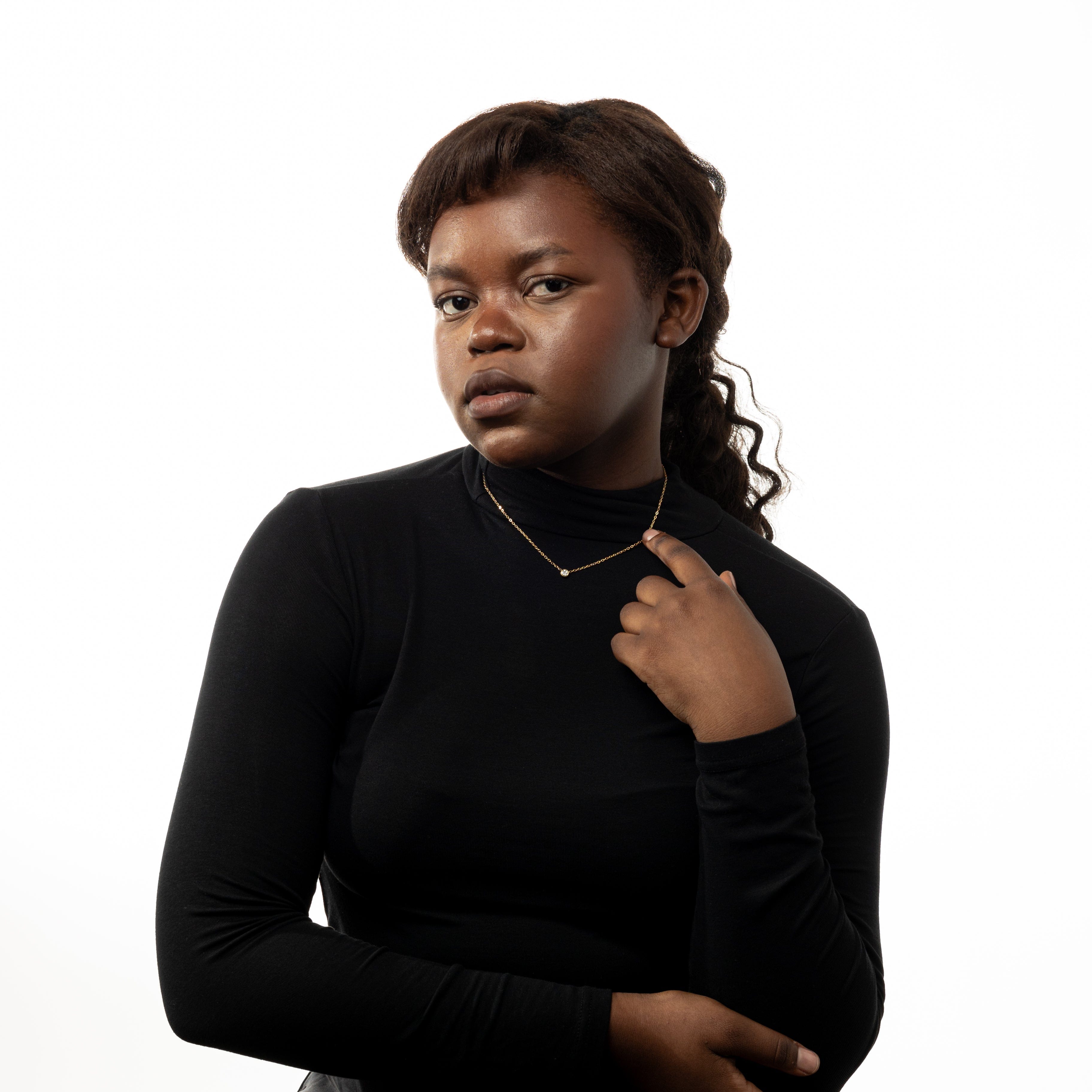 Radiant gold bezel gemstone necklace displayed on a model, showcasing its shine and minimalist design.