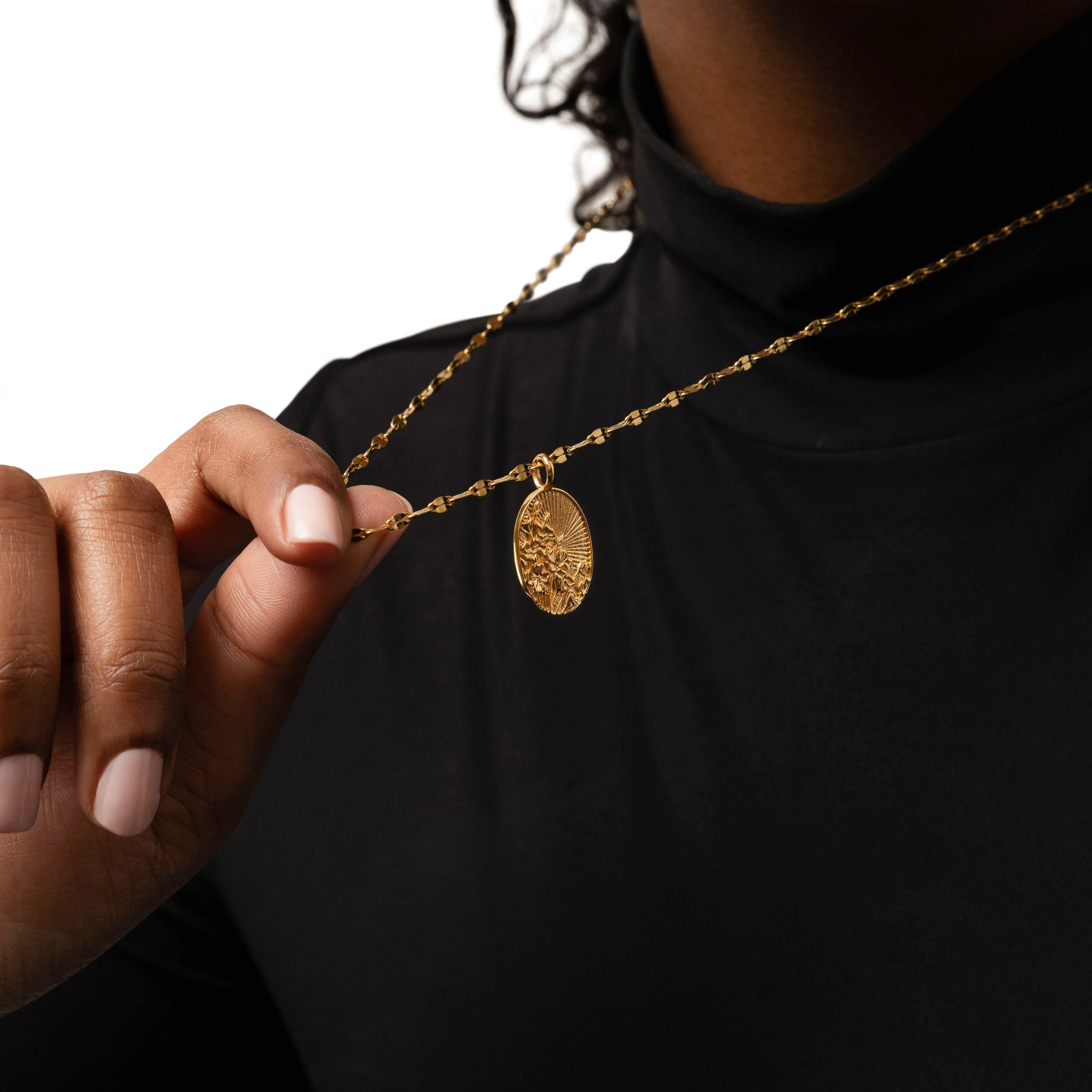 Model wearing the gold pendant at a length of 22 inches, showcasing its elegance and versatility.