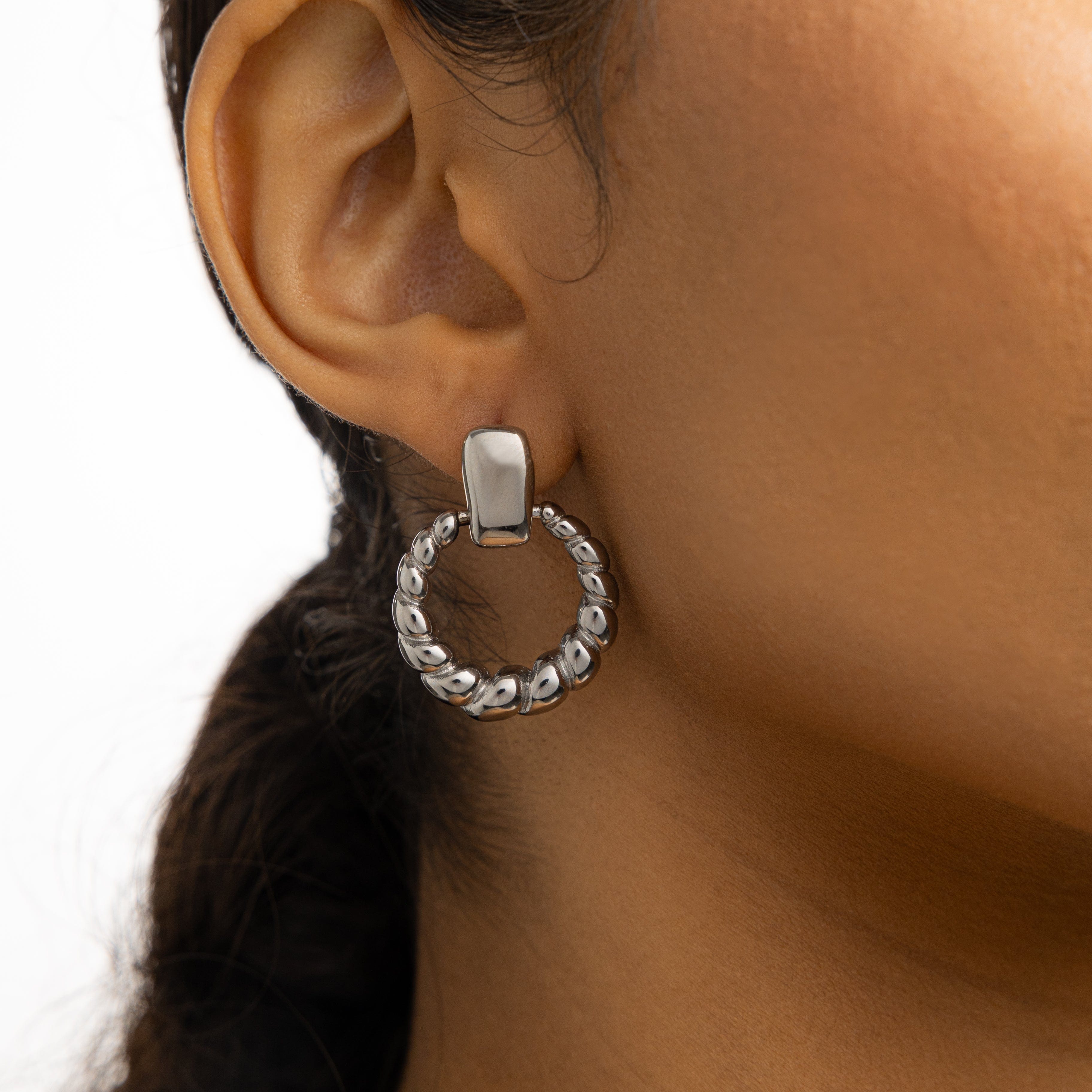 Model wearing the best gold hoop earrings for sensitive ears, styled for a casual look.