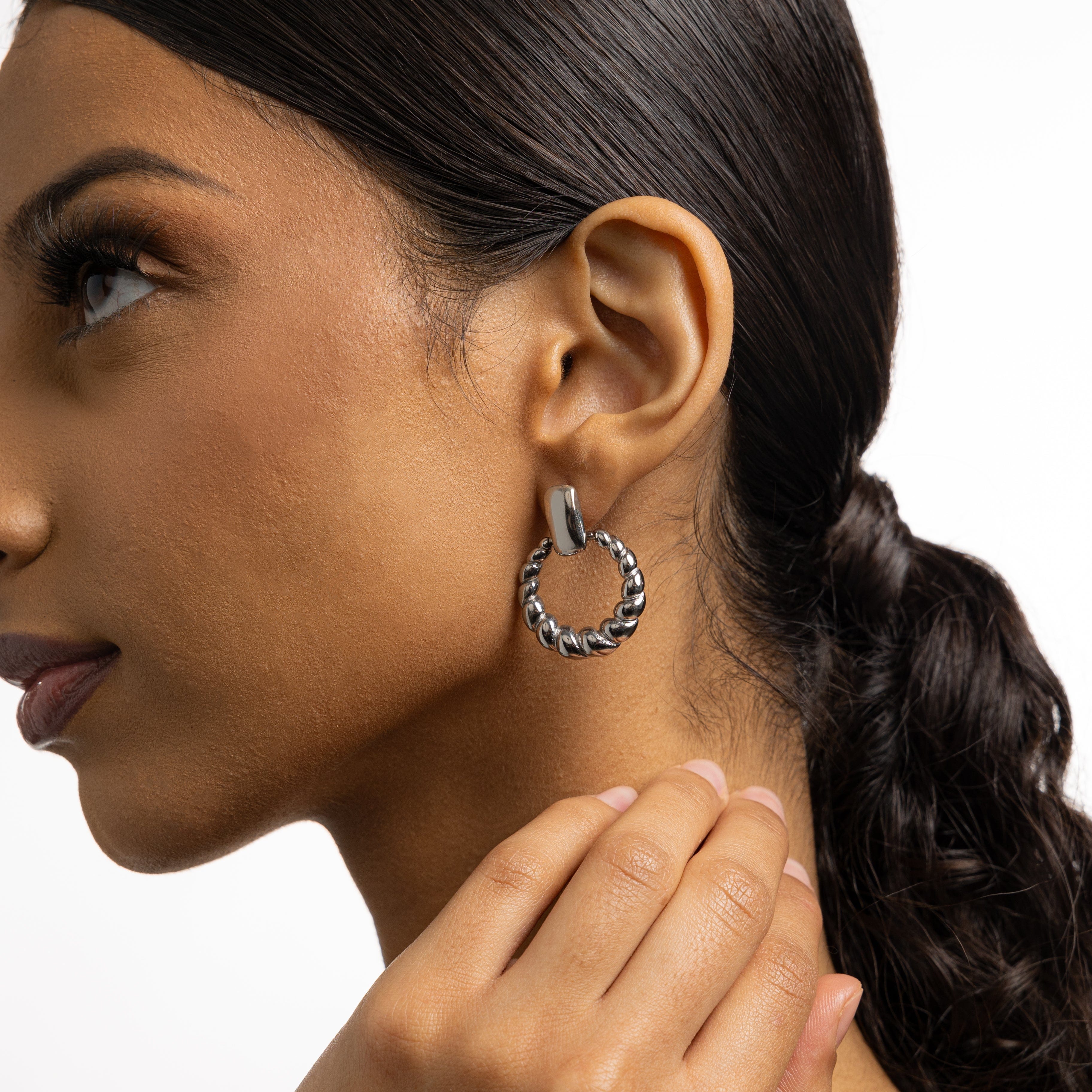 Chic braided statement hoops showcasing luxury design and waterproof feature.