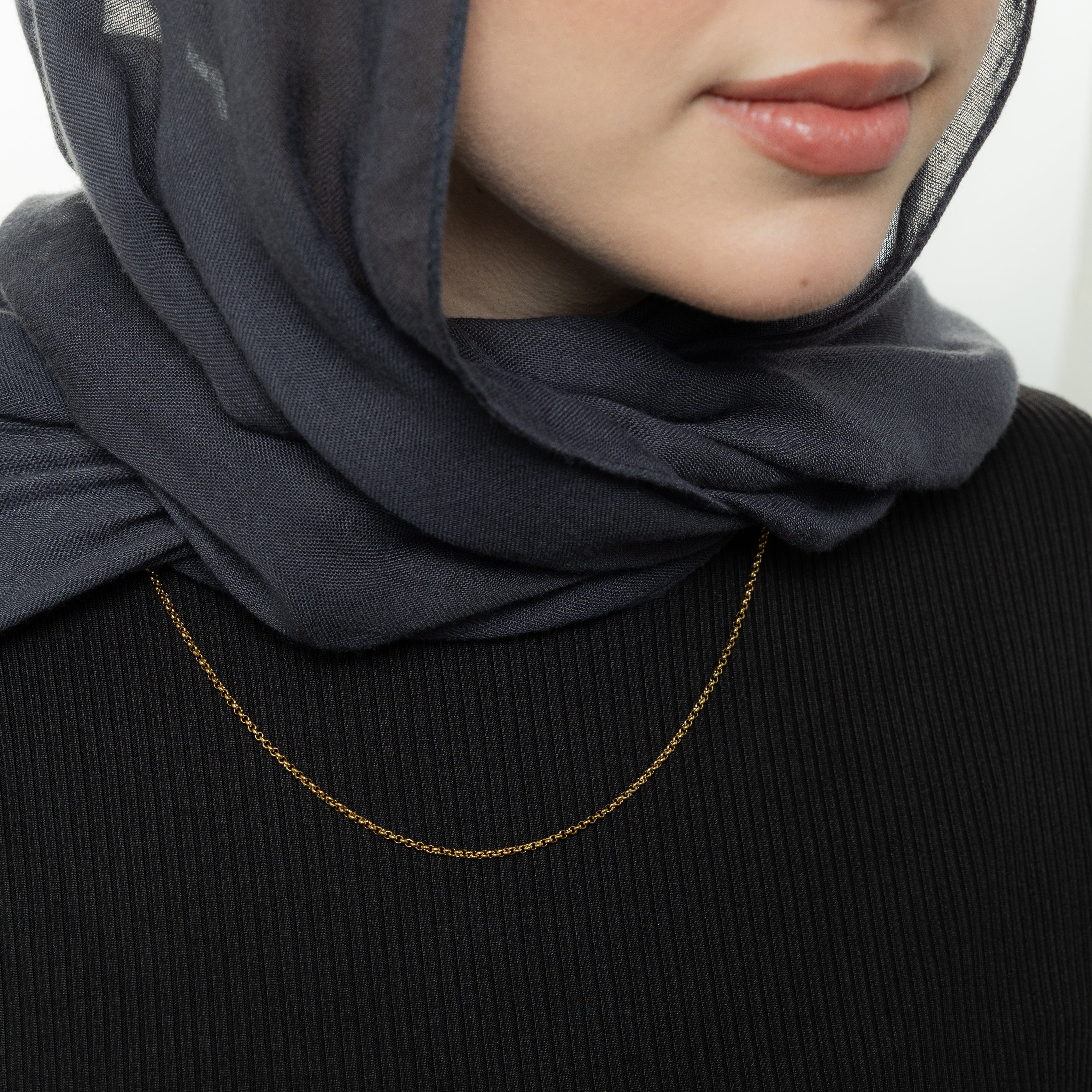 The bracelet styled on a wrist with other dainty hypoallergenic jewelry pieces for a stackable, everyday look.