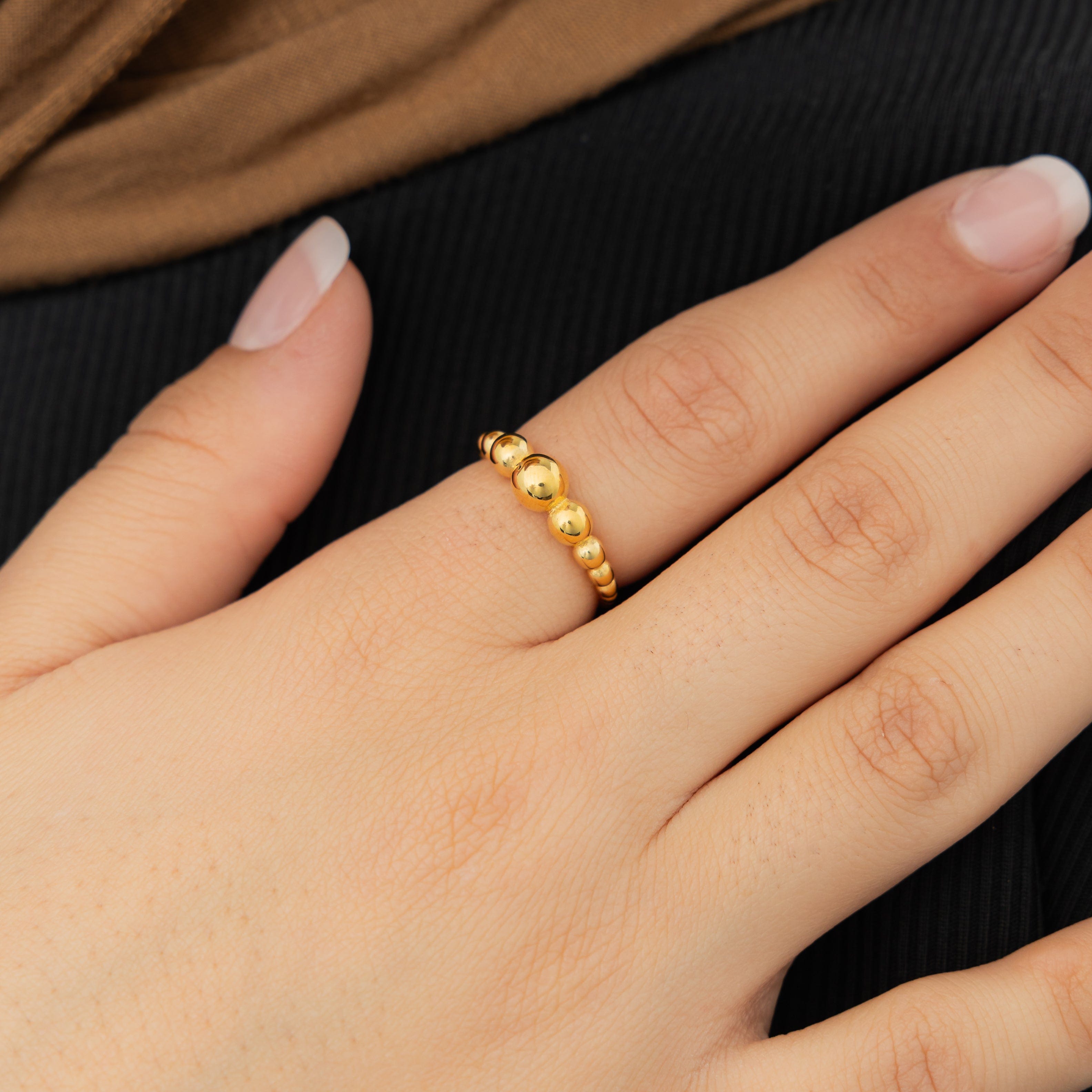 Close-up of the Bubble Ring on a finger, showcasing its elegant tapering band.