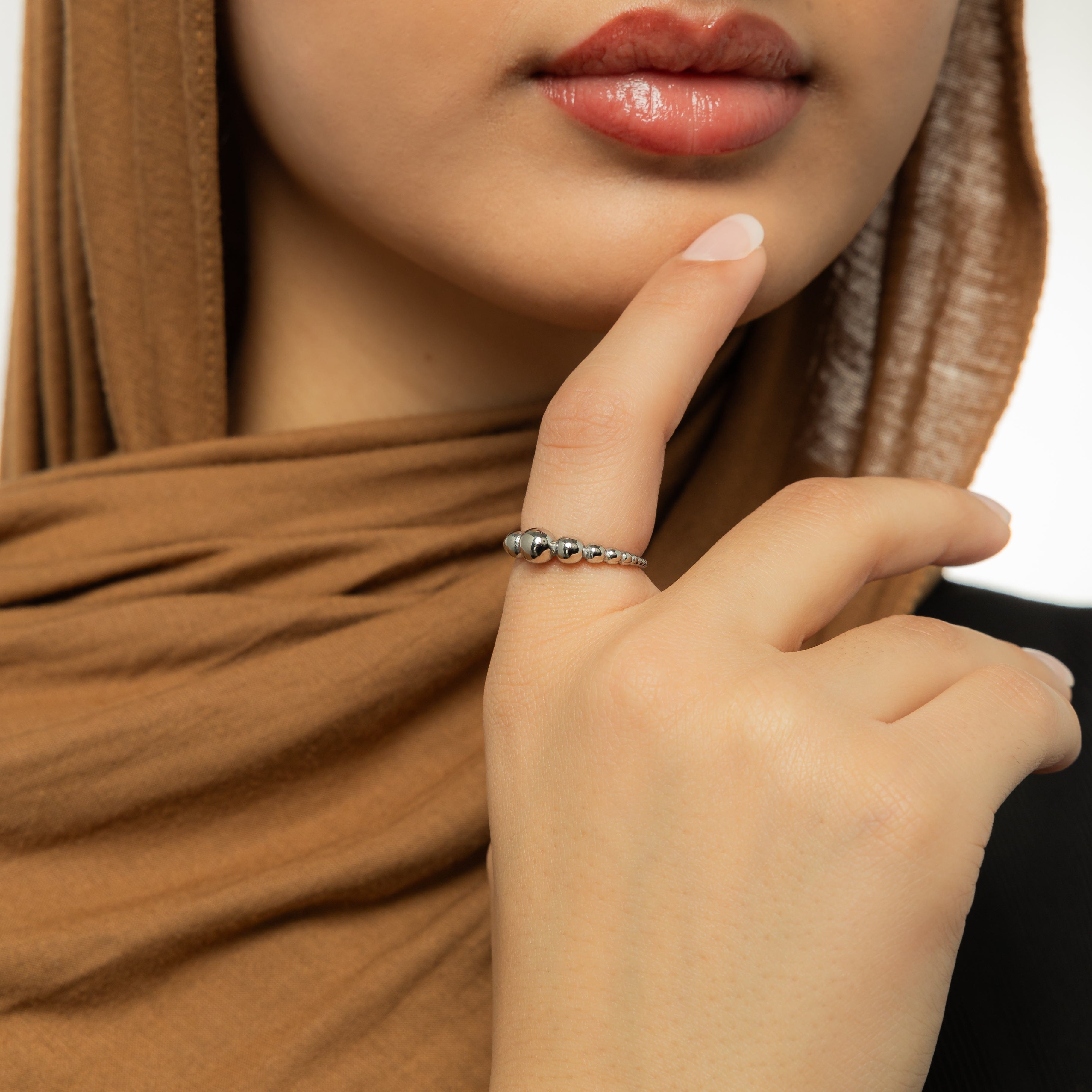 Chic Bubble Ring displayed in velvet pouch, highlighting its dainty design and 18K gold plating.