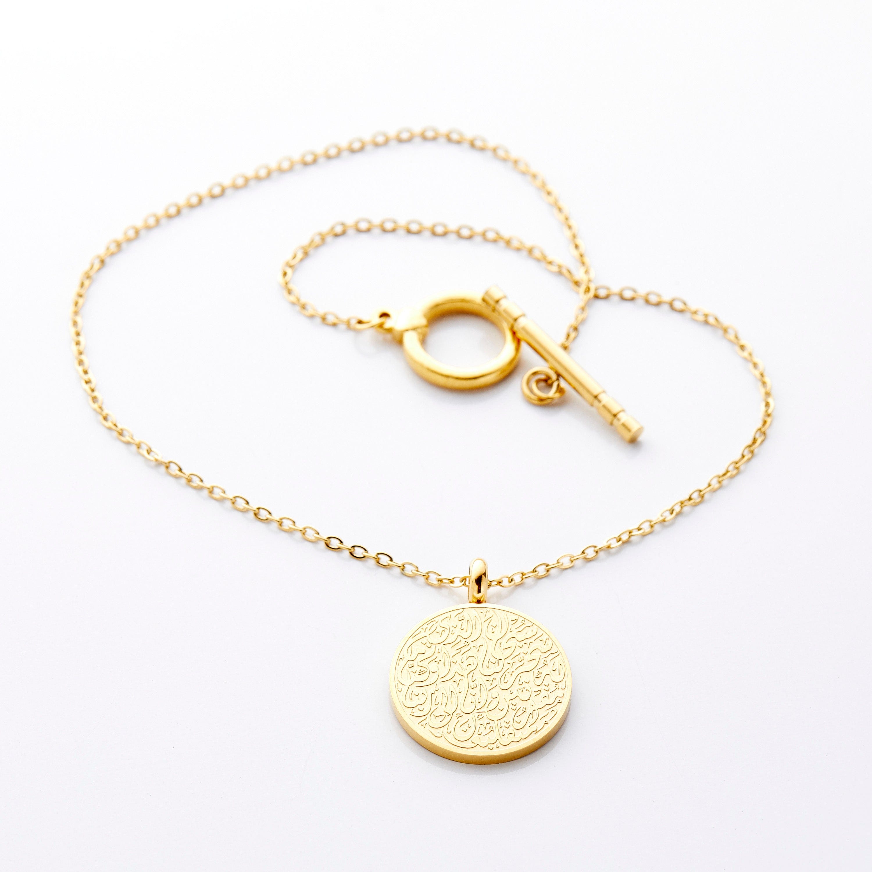 Elegant 18K Gold Travel Prayer Car Hanger displayed on a car dashboard, showcasing its beautiful engraving.