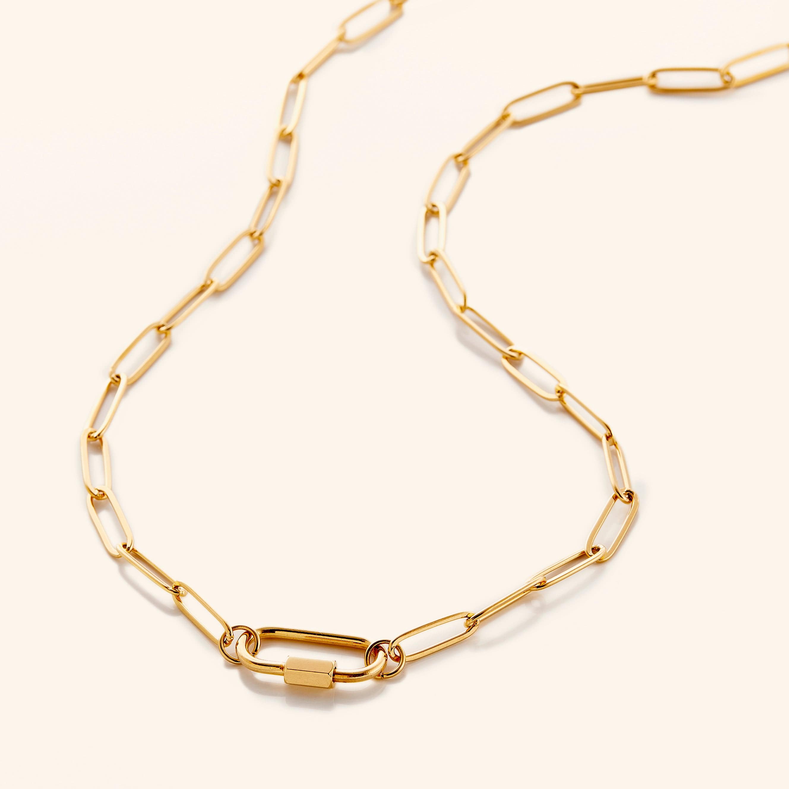 Close-up view of the personalized charm necklace with carabiner clasp, showcasing its gold plating and adjustable chain.