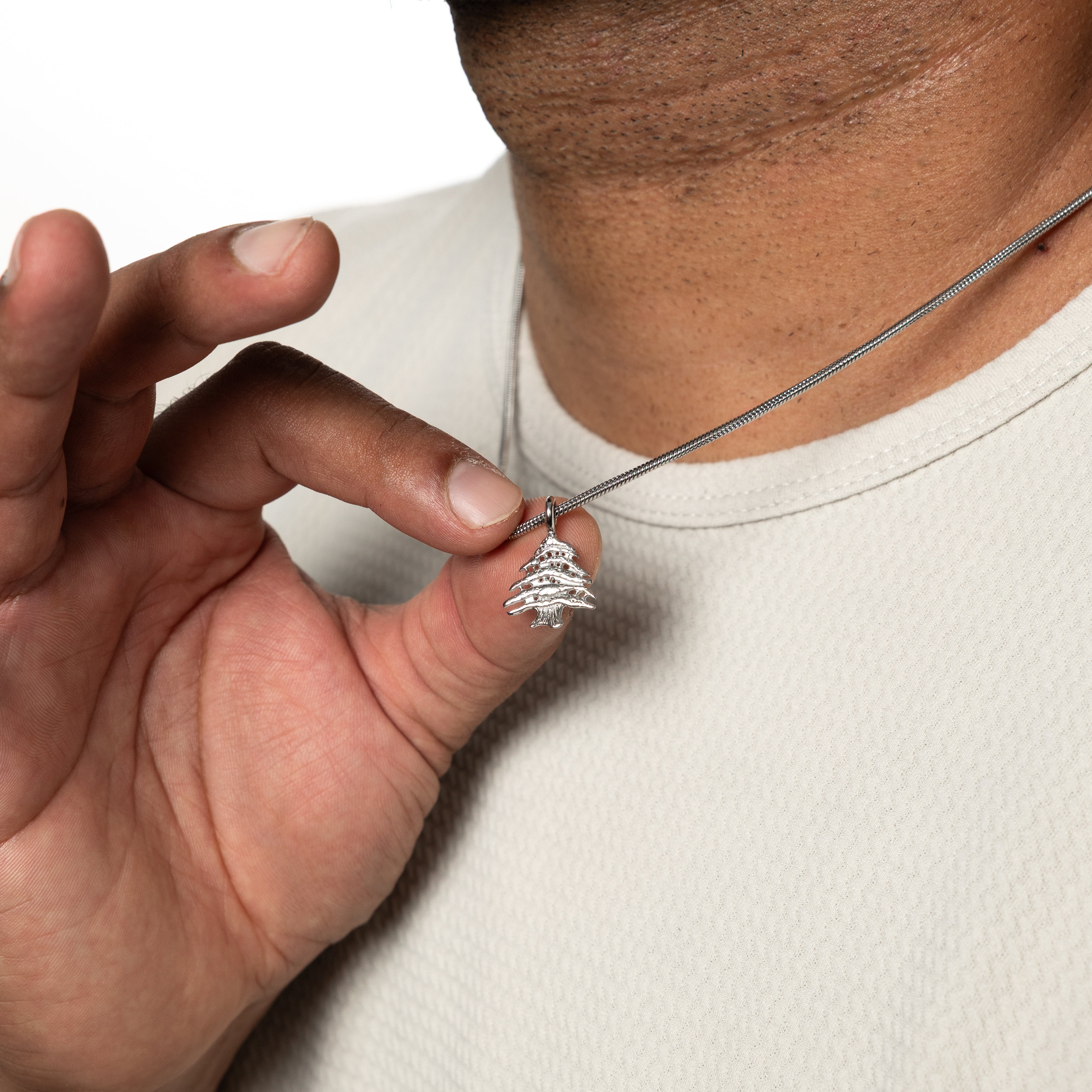 Cedar of Lebanon mens necklace laid flat on a velvet pouch, perfect for gifting or personal use.