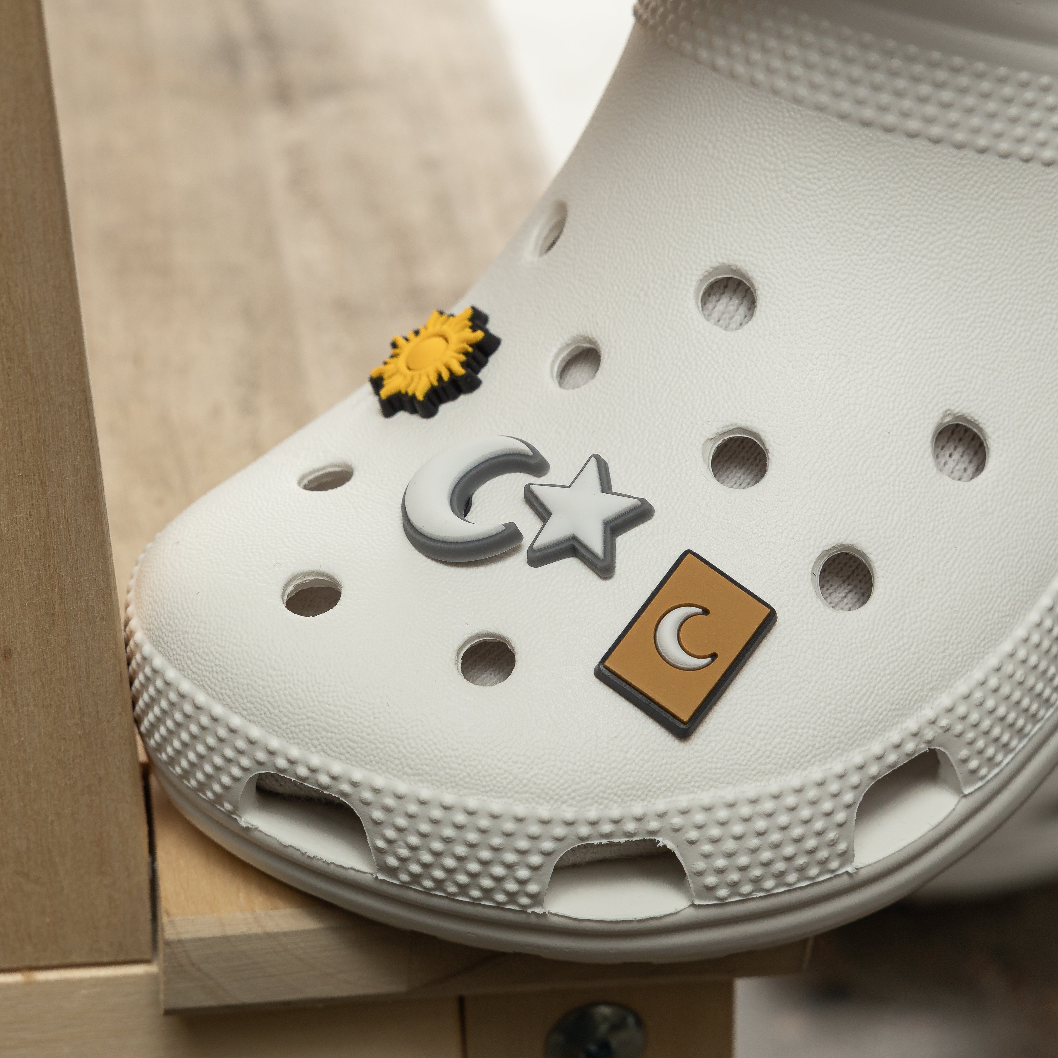 Stylish Crocs adorned with celestial charms, highlighting their unique and personalized touch.