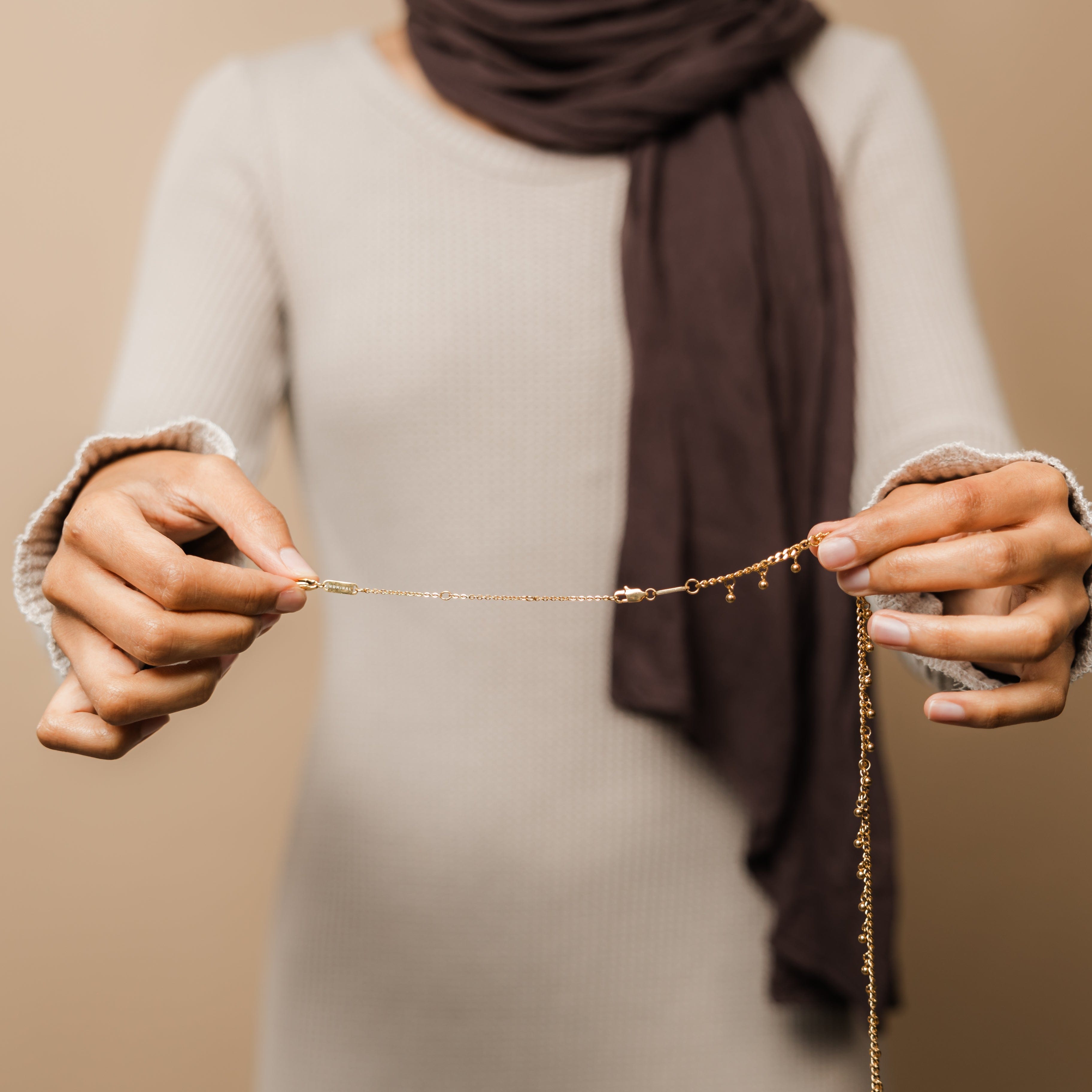 Versatile chain extender displayed alongside elegant necklaces.