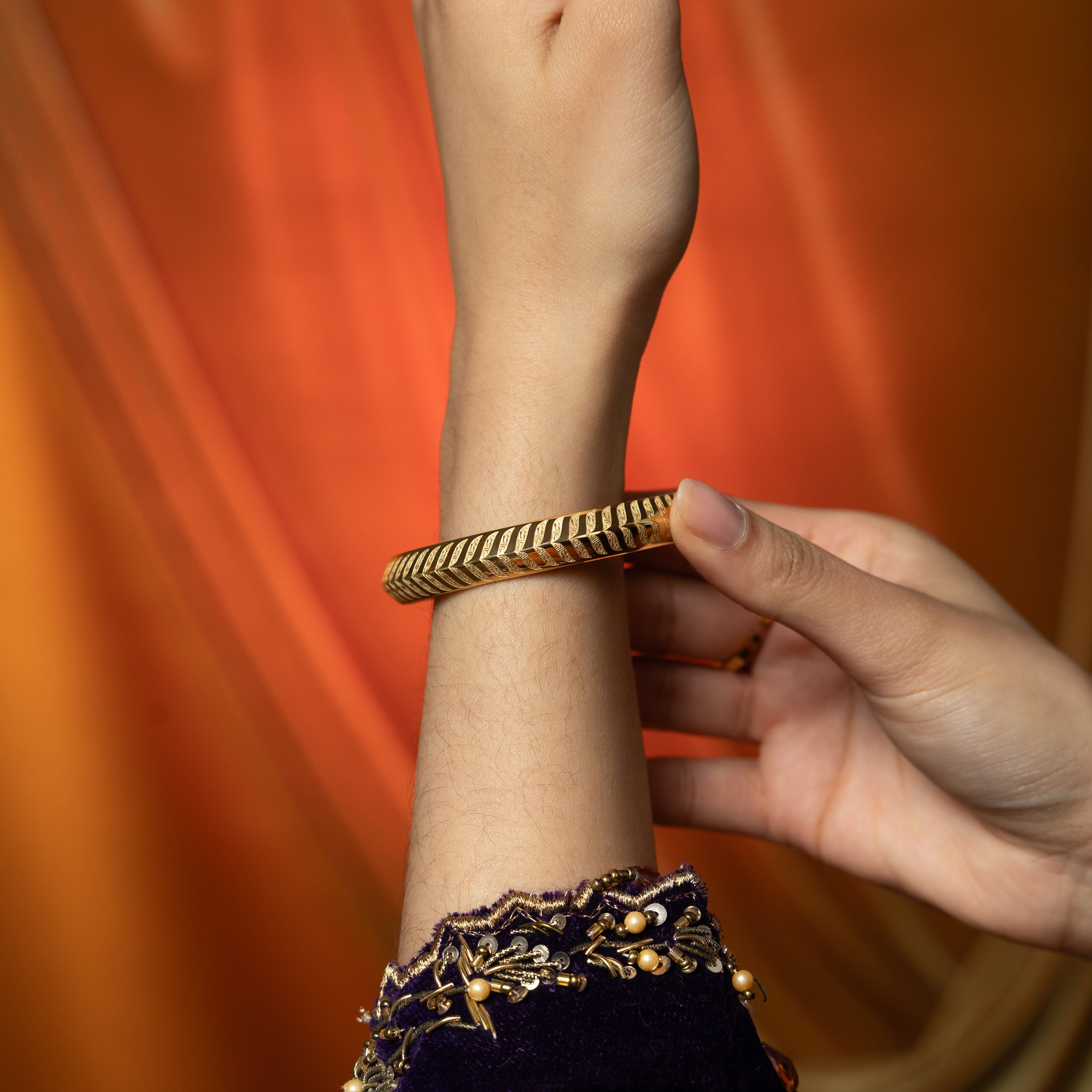 Elegant presentation of the Kun Faya Kun Gold Bangle in Nominal Velvet Pouch