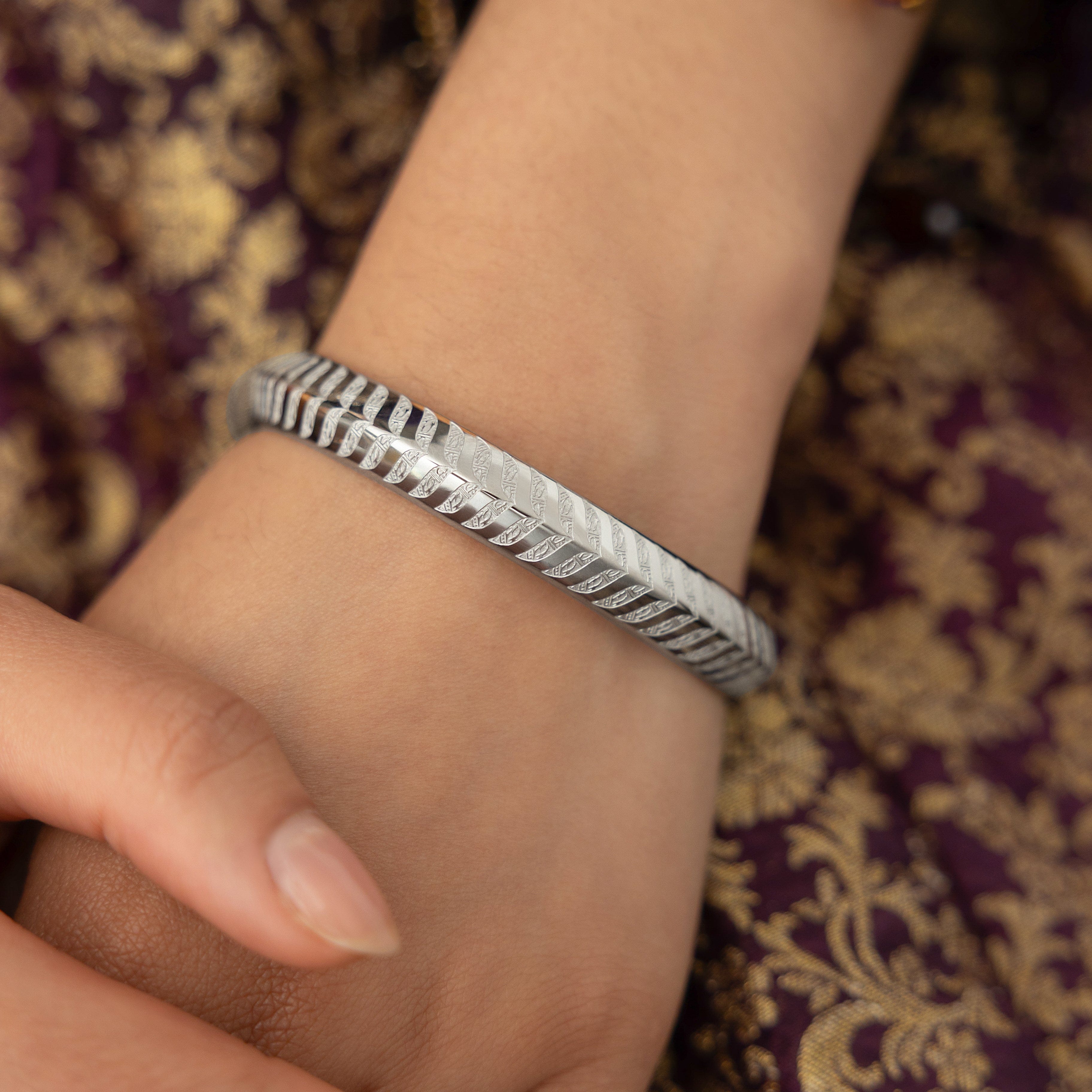 Elegant presentation of the Kun Faya Kun Gold Bangle in Nominal Velvet Pouch