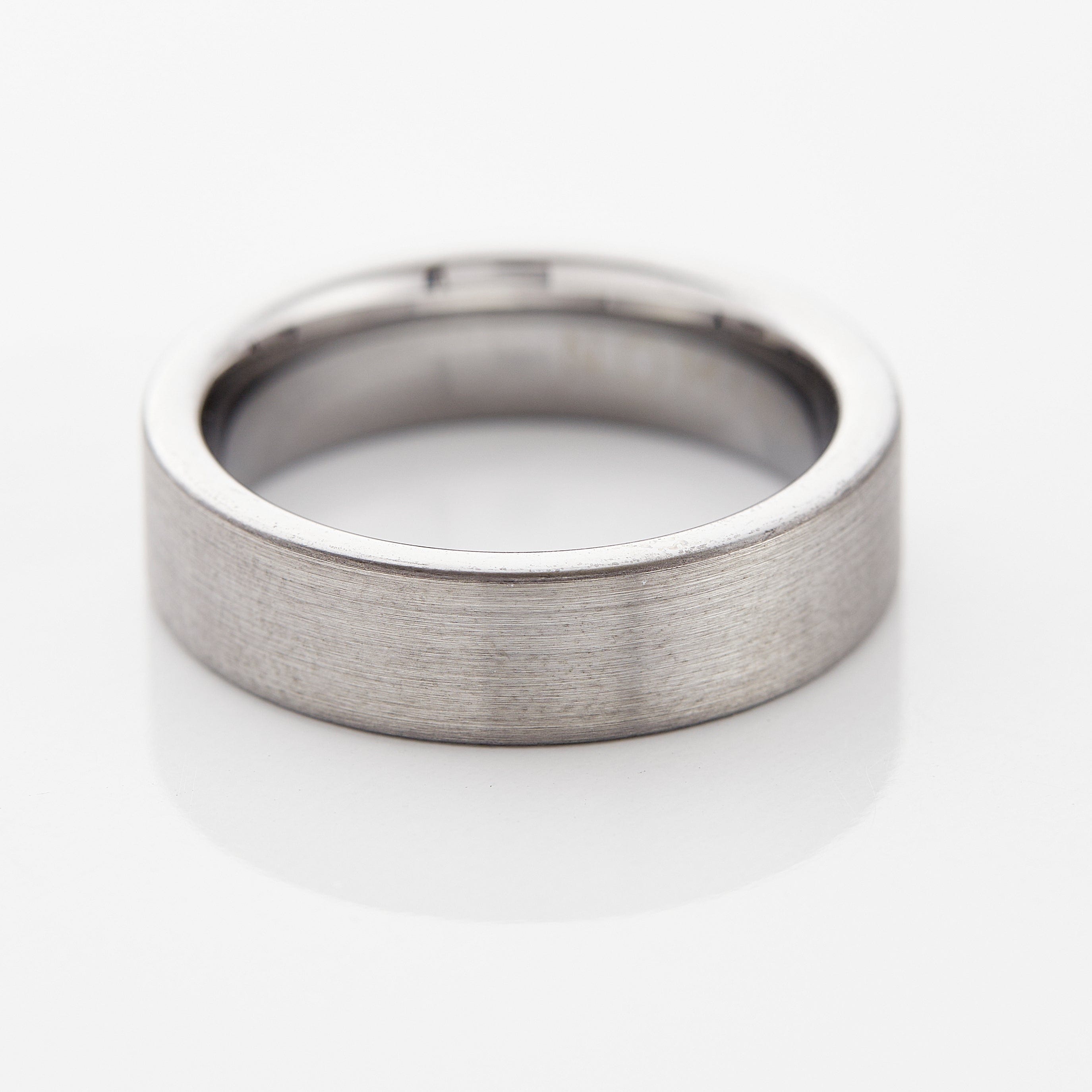Close-up of the eternity flat tungsten ring showcasing its brushed finish.