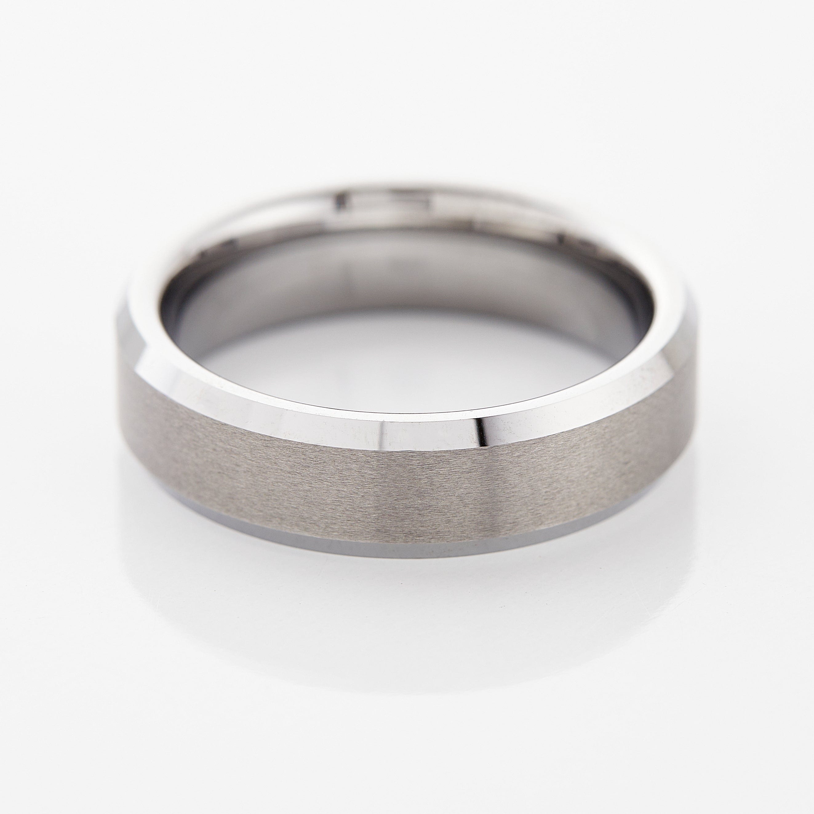 Close-up of Timeless Tungsten Men's Ring with brushed finish and glossy beveled edges.