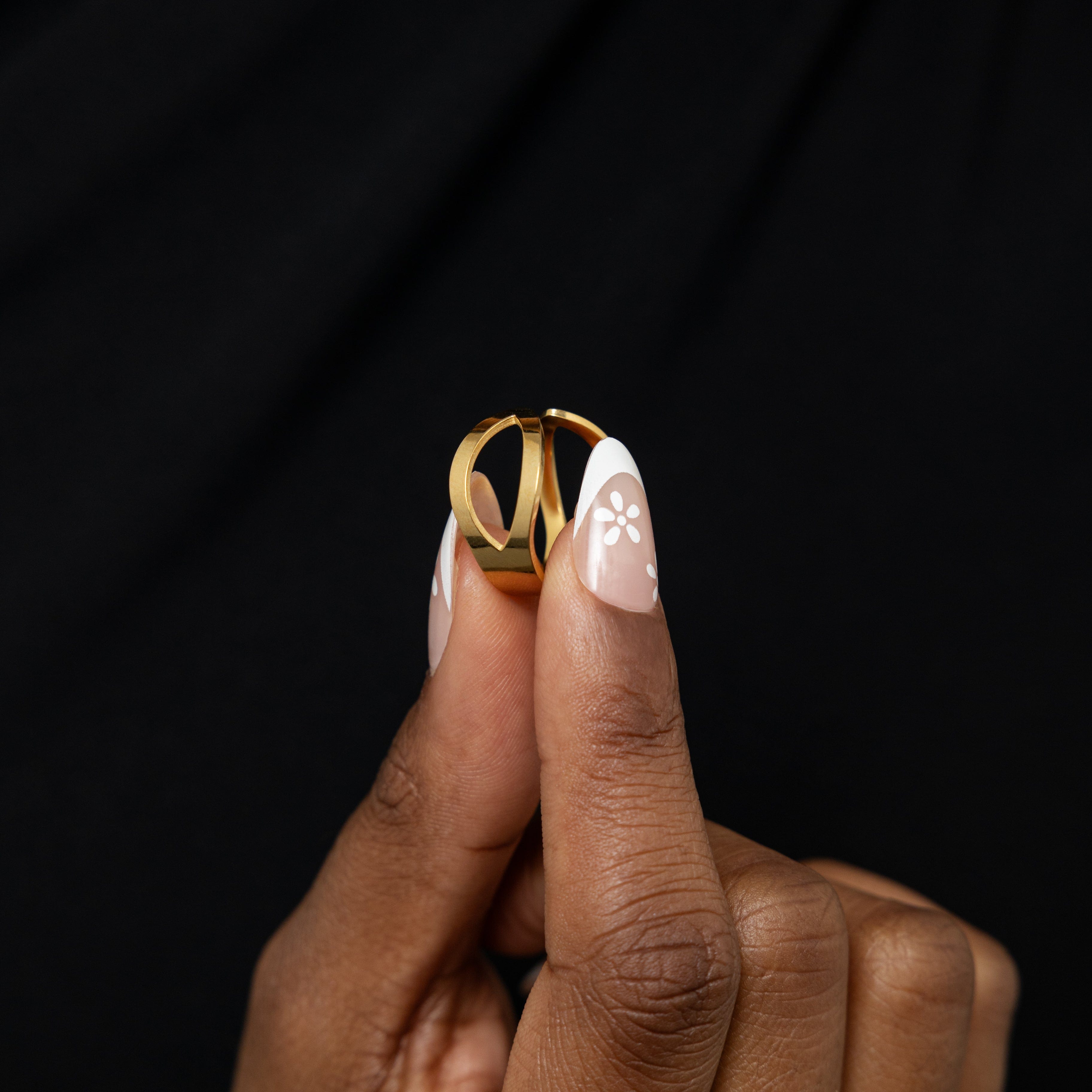 Close-up of Corridor Elegance Ring showcasing its tapered wing-like design and gold plating.
