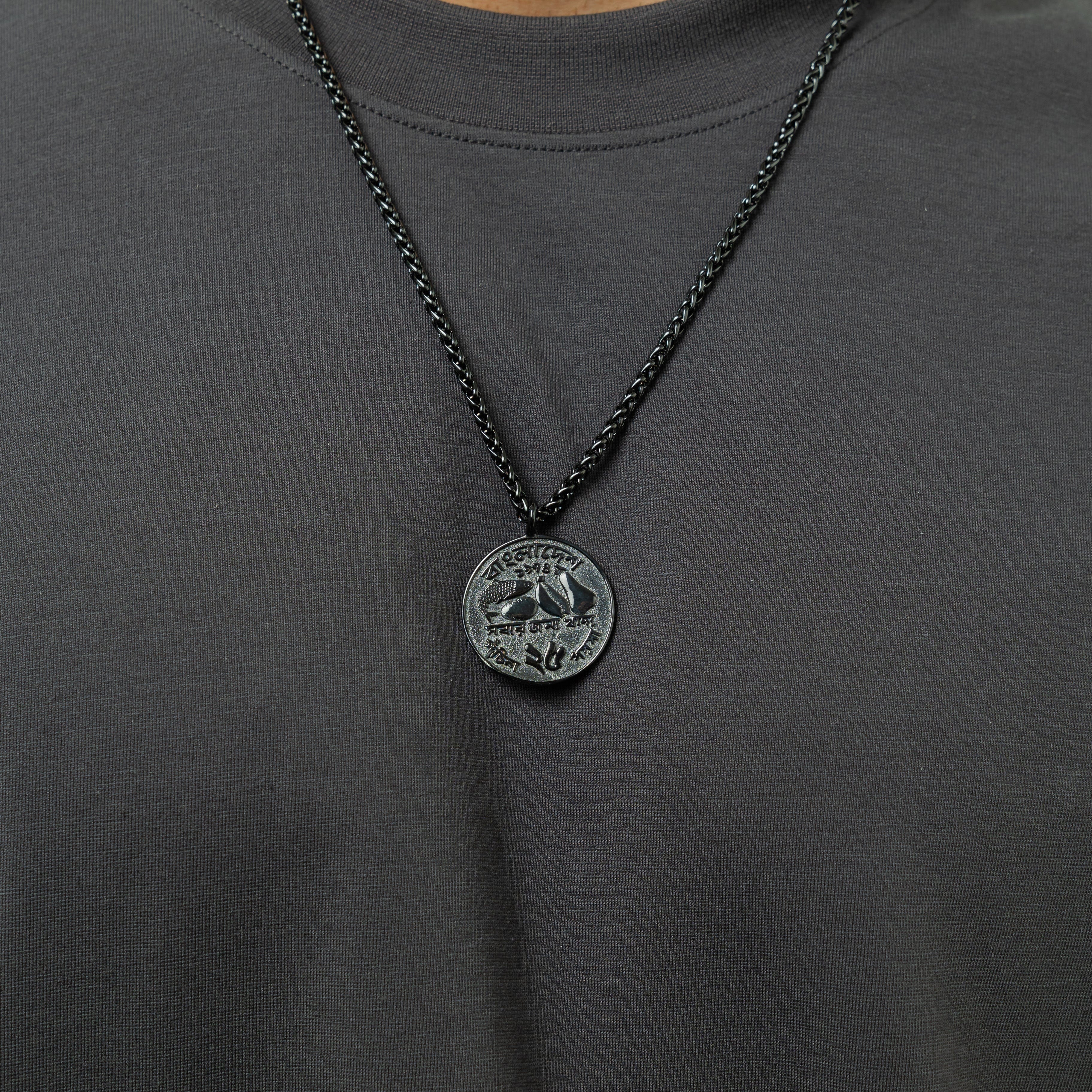 Lifestyle shot of a man wearing the premium mens coin necklace, styled with casual attire.