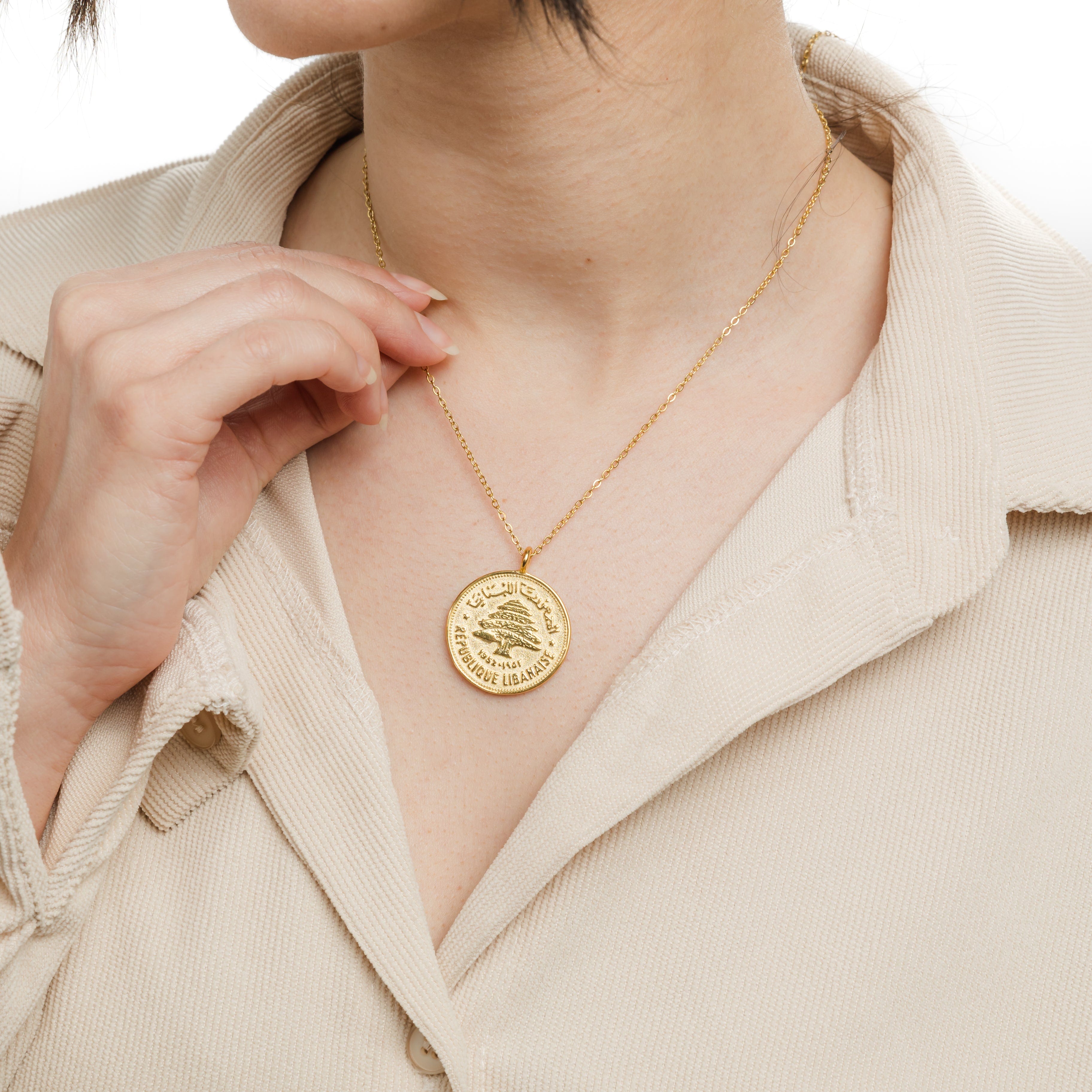 The Heritage Coin Necklace displayed in a velvet pouch, perfect for gifting.
