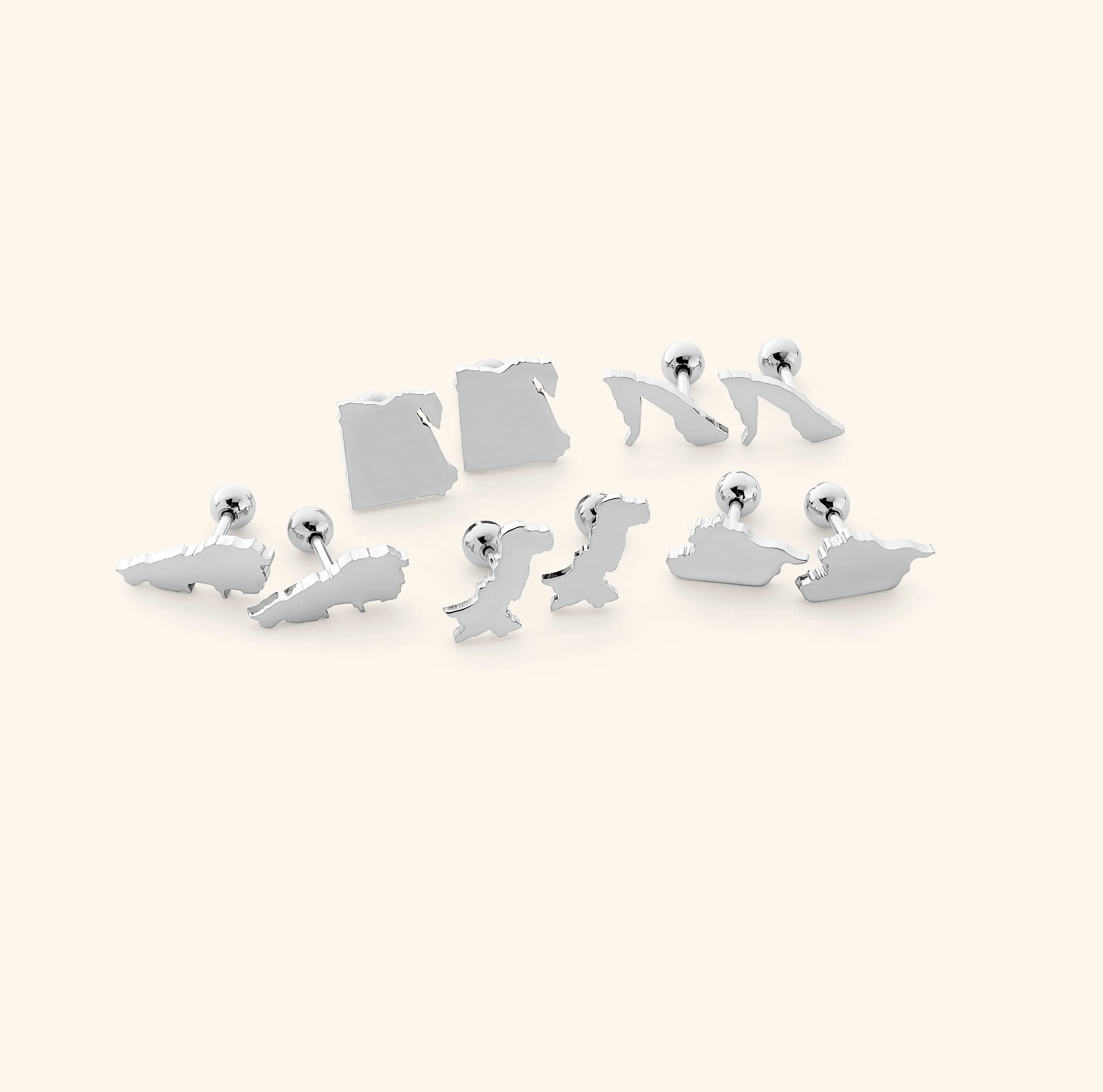 The Timeless Country Gold Stud Earrings elegantly displayed in a drawstring pouch.