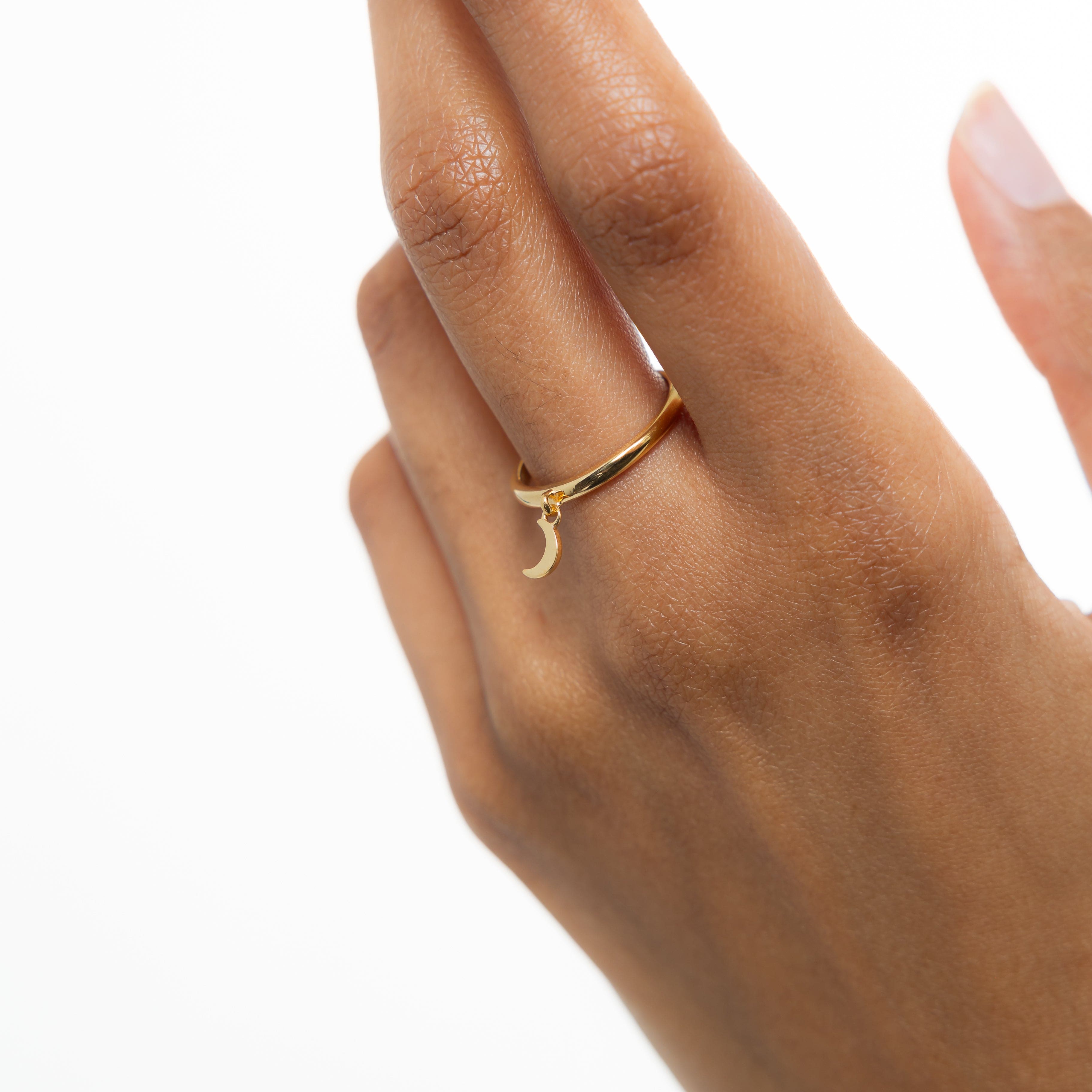 Lifestyle shot of gold ring on womans hand, showcasing affordable dainty rings for everyday wear