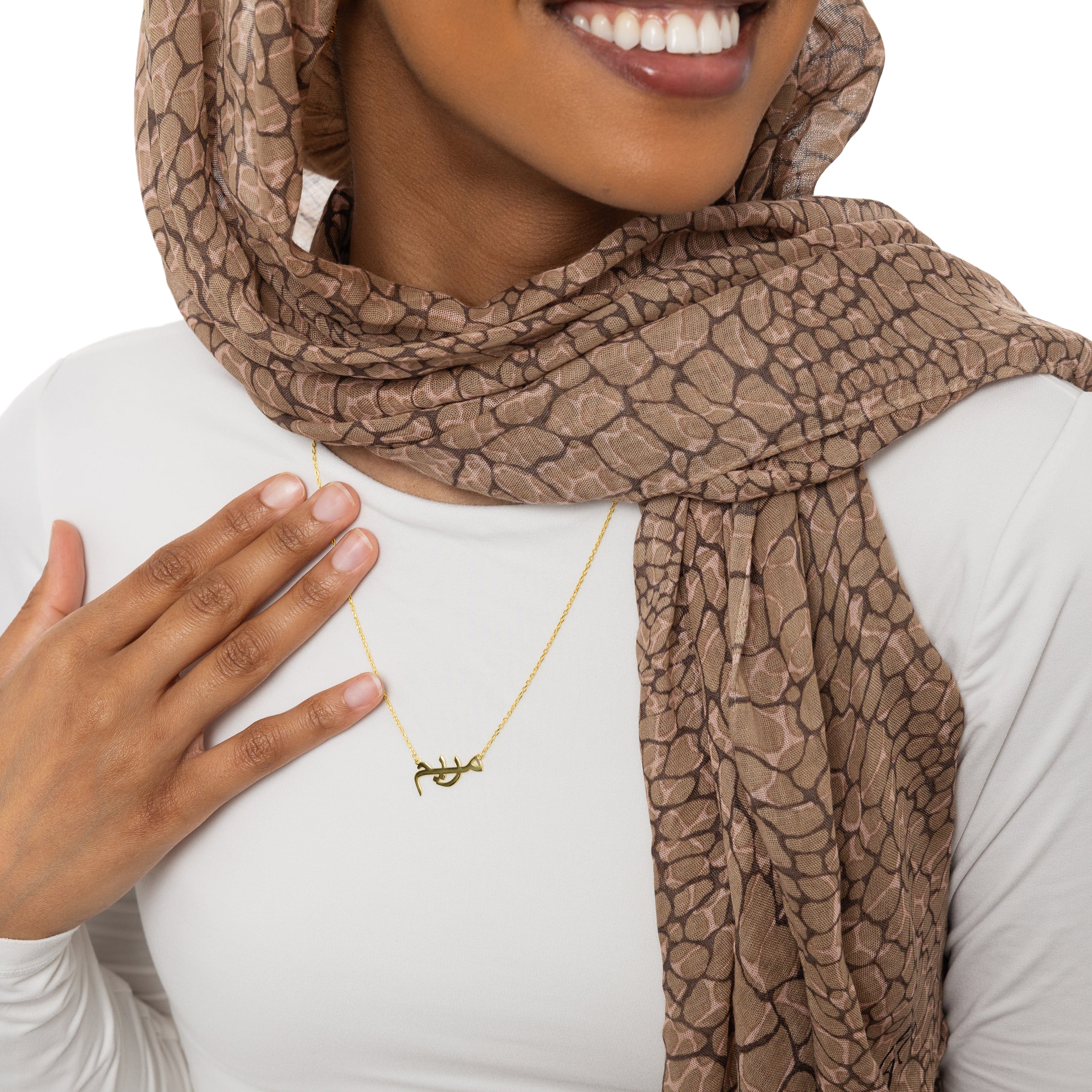 Close-up shot of the unique name necklace in gold, showing intricate details and craftsmanship.