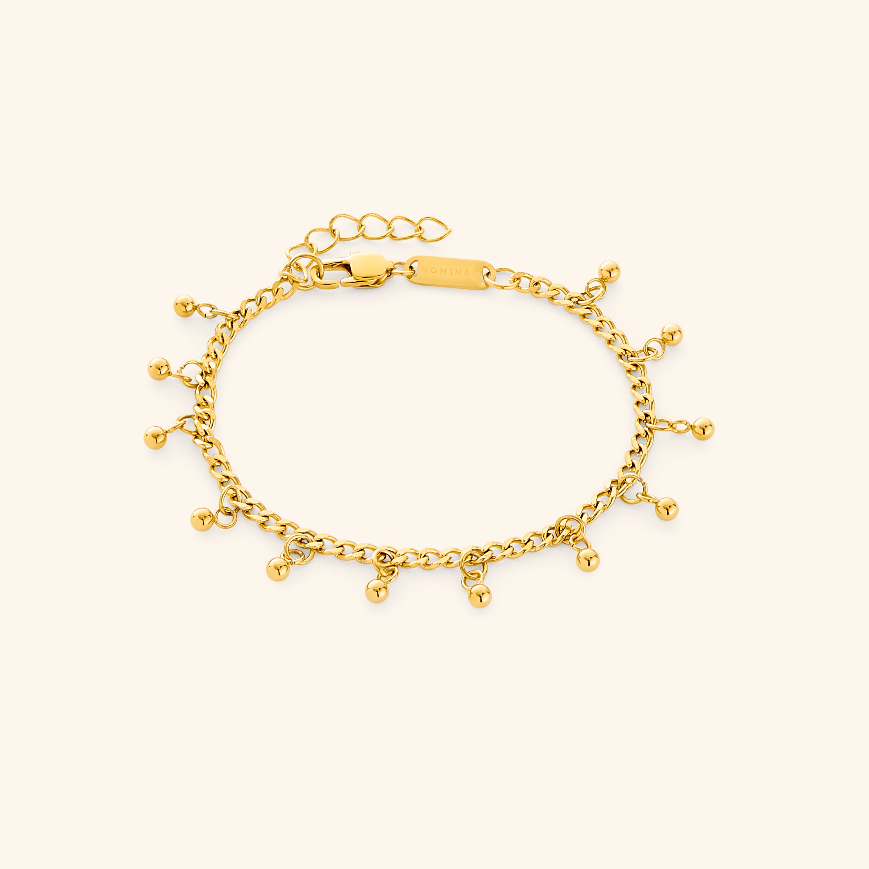 Elegant dotted charm bracelet with dangling charms, showcasing its intricate design.