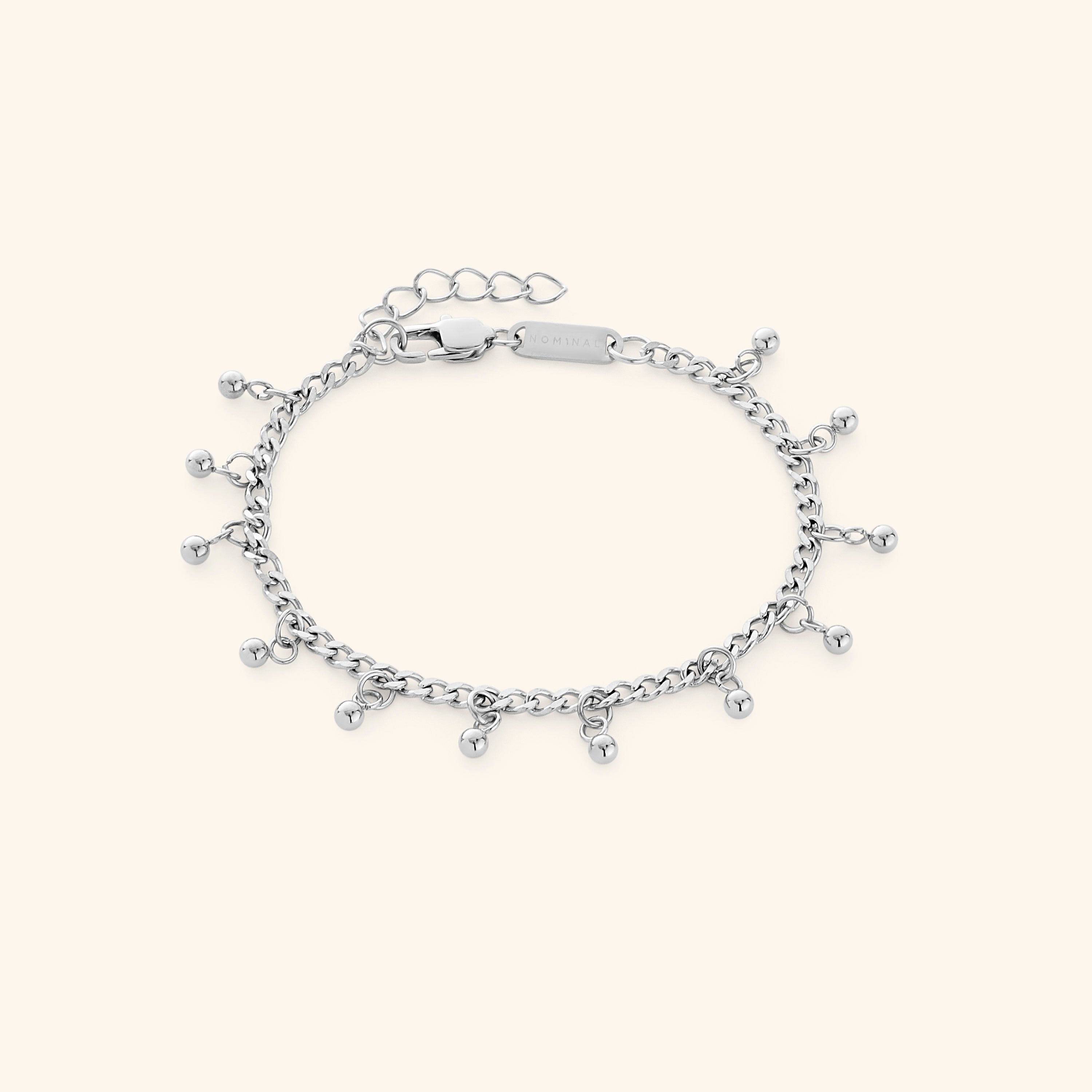 Dotted charm bracelet styled with casual wear, perfect for daily use.