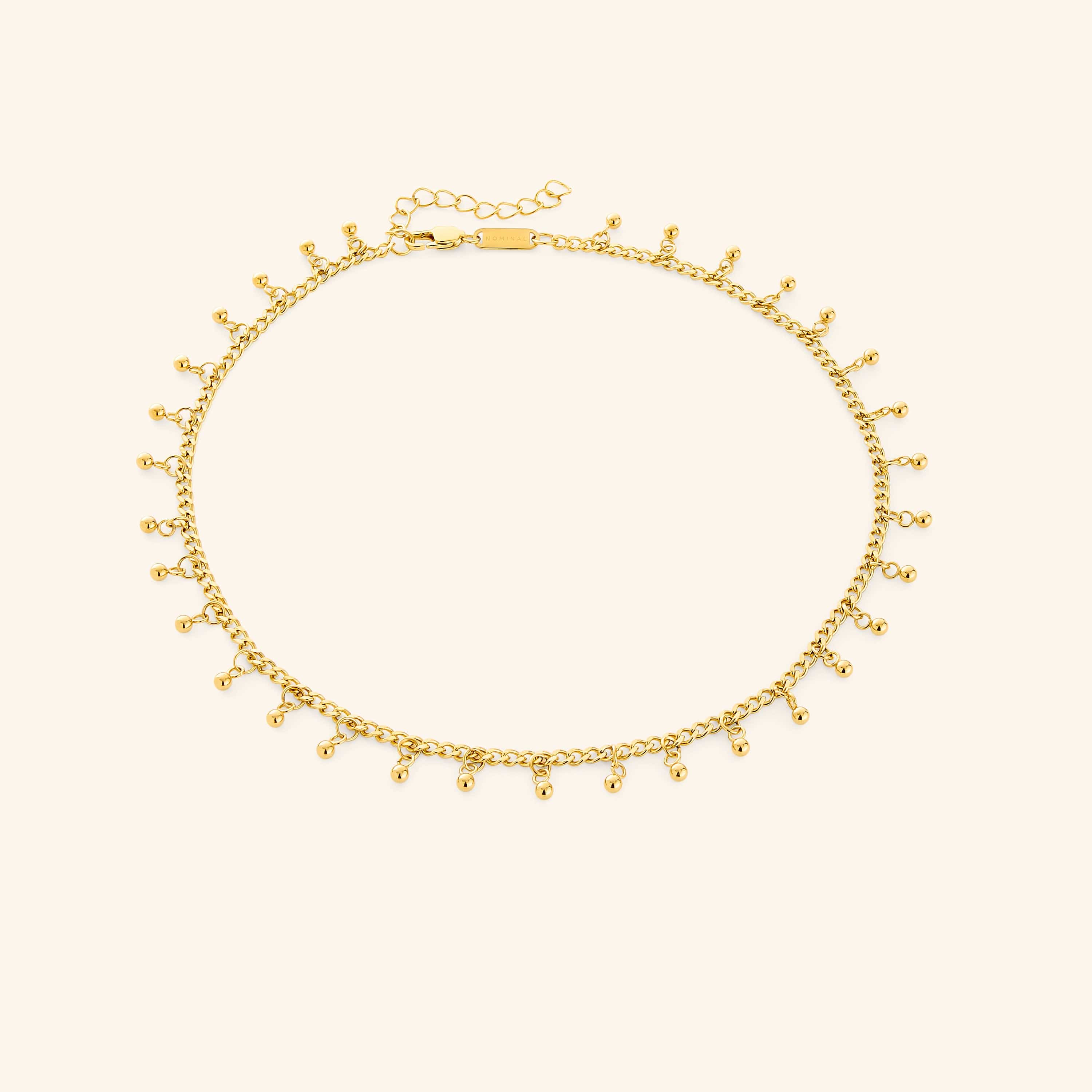 Close-up of Luna Dot Drop Choker lying flat with dotted charm detail visible — a minimalist choker design